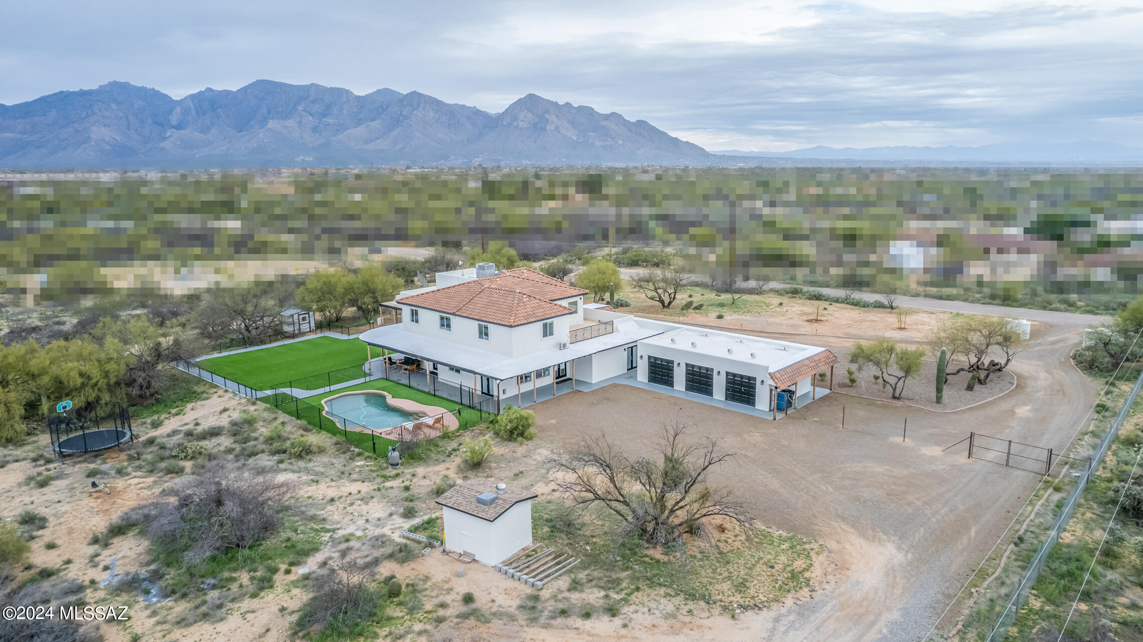 POWER and WATER COST LESS THAN $25/mo! This sunning 4762 sqft home sits on 5 useable acres with views of Catalina and Tortorlita Mountains ! GUEST HOUSE with separate entrance. You'll love the updated interior with spacious bedrooms and living areas. Kitchen is gorgeous w/ new quartz countertops and a large, custom pantry. Family room includes a short throw projector with a 120in ALR wall mounted screen. 3-car garage, private well, OWNED solar! A/C is 2 years old, property is fenced, outdoor space includes pool, artificial turf, wrap-around patio, full-length front porch, and professional landscaping. Basement storage room. Additional building site in the back of the property has electric, septic, and water ready to go! Has HORSE privileges. This home is a must see.