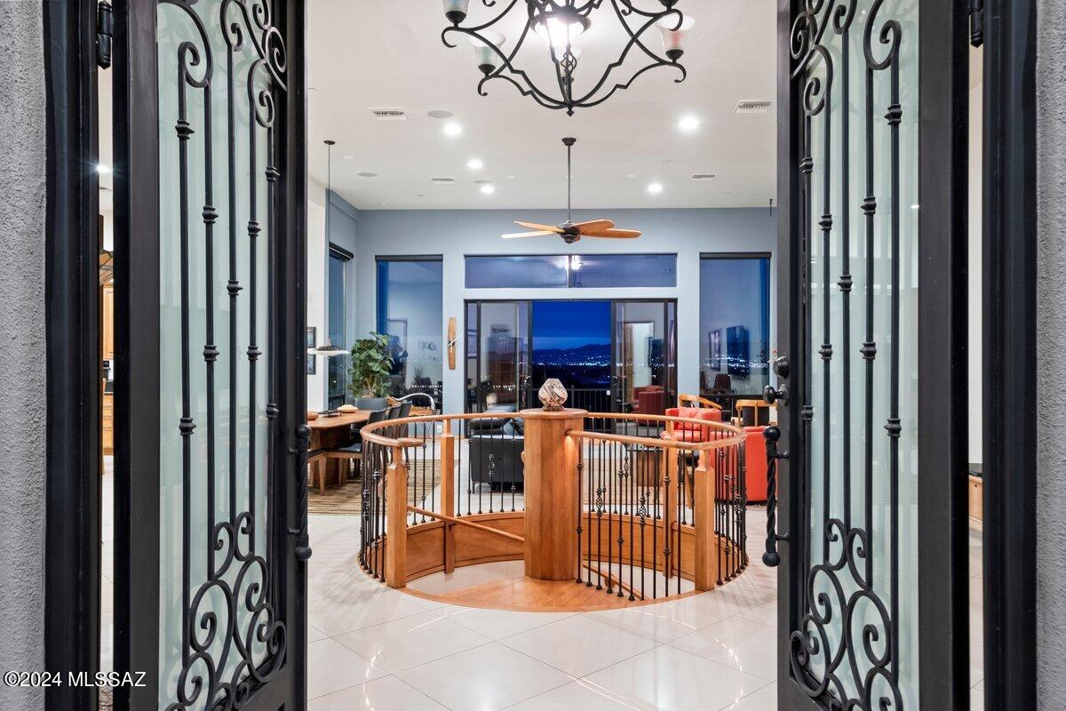 A magnificent fusion of VIEWS and a 4164-sf home with massive 5-car garage on 3.33 acres in the Tucson Mountains. Custom design by award-winning architect, Marc Soloway, positioned with N/S exposure for energy efficiency with brilliant mountain views by day and a dazzling skyline of city lights by night. Multiple patios extend the luxury of front row seating to a stage of lush desert landscape featuring wildlife, bold sunsets and stargazing. Beautiful 8' solid maple doors and cabinets, granite counter tops, 24''porcelain tile and central vacuum throughout the home. Great Room design with soaring ceilings and an abundance of natural light. Your Gorgeous fully equipped kitchen features 2 islands, wine fridge, convenient beverage cooler and a quartet of appliances. 3 bedrooms, 2.5 bath, large office (could be 4th bedroom), a multi-purpose Flex room with private patio, deluxe laundry room with ample cabinet space, sink and double washer/dryer sets. A spiral staircase delivers an elegant entrance to the lower level with a wall of windows revealing the marvelous view of the Catalina Mountains and panoramic skyline views that showcase the expansive Great Room, kitchenette, bedroom, walk-in closet, and bathroom. Just beyond the bustle of the city, yet minutes from I-10 and downtown Tucson.