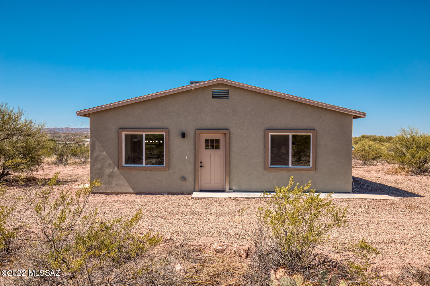 Seller may accept or counter offers from $300,000-$330,000. Your chance to own a new home on over four acres of land. Sweeping views all around and flexible zoning. This home was completely furred out with OSB during construction. Shingle roof and synthetic stucco for exterior durability. Inside you'll find an open living space with 9 foot ceilings. Three bedrooms and two full bathrooms. The kitchen and bathrooms are equipped with custom built cabinets and granite countertops. Luxury vinyl plank flooring runs throughout this home. Come enjoy the quiet living in your new home. Seller is licensed to sell real estate in the state of Arizona.