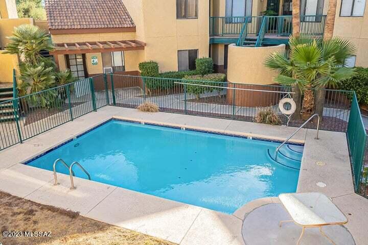 RENOVATED 2 bedroom and 2 bathroom 2nd floor condo overlooking the community pool, in the popular midtown Park Place Village Condos on Country Club. You will love the vaulted ceilings here, the living room features a wood burning fireplace and an abundance of natural light. The light and bright kitchen has Granite countertops, S.S. appliances, plenty of storage and access to the back private balcony with mt. views. The spacious split-bedroom open floor plan offers large walk-in closets and en-suite bathrooms with shower & tub. The condo also features a laundry closet with washer and dryer included. Great neighborhood near the Tucson Racquet & Fitness club, the Loop Trail, and Rio Vista Natural Resource Park. Convenient to the U of A, plus dining and shopping and transportation.