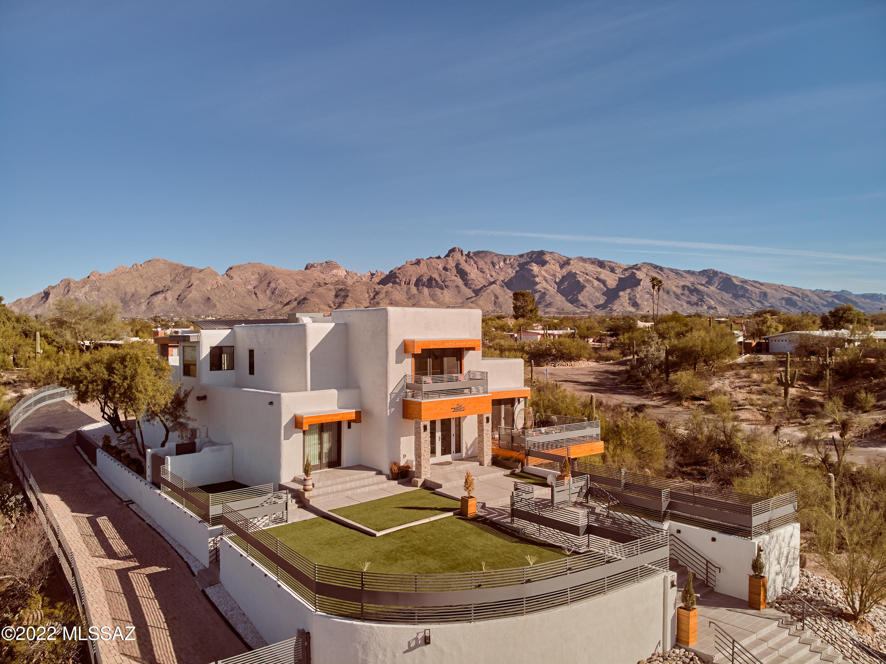 Views, the one word that encapsulates what this exquisite estate is about.  Situated on a .86 acre, lot this masterpiece has been thoughtfully designed to take advantage of the panoramic view of the Catalina  Mountains to the north and the one of a kind view of the city to the south.  The custom designer grand staircase leading to the front of the home is the first thing you will notice on this LeBlanc original.  Once you ascend you will see the magnificent views of the city from the front courtyard.  At night is when the magic happens when downtown and the rest of the city lights up leaving you in awe.  These views are also visible through the custom doors in the living room and the dining room as well as the City View Bedroom. On the second floor of the main residence you will find the owners suite.  Besides the typical amenities you would expect from a property of this caliber you will find a patio to the north with breath taking city views, a separate den area, an office and a rear patio.  This rear patio overlooks the complete Catalina Mountains from East to West.  

Once you exit the rear of the house you will find your own true resort.  With the Catalina Mountain in the background, you can relax year-round at your oasis that has a heated Pebble Tec pool and full outdoor kitchen featuring Lion BBQ fixtures.  Natural gas is connected to the pool heater, space heaters and the grill and range.  There is also an outdoor television.

At the other end of the resort area you will find the one of a kind permitted 2-bedroom guest house.  This truly modern marvel features smart appliances and blinds, a full kitchen, full size washer and dryer and on demand water heater.  The theme of views extends to the guest house as the main bedroom has mountain views through the window and a view of the resort area out the double door opening.