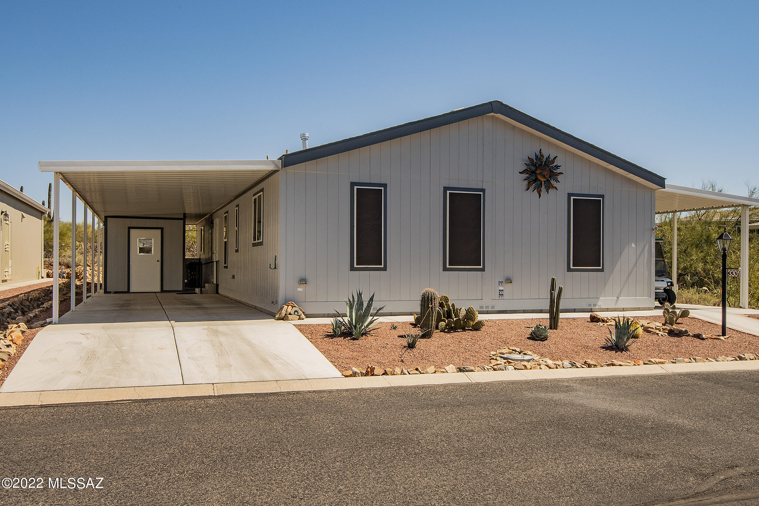 This is the one! Lovingly cared for 2016 manufactured home situated at the top back corner of beautiful Copper Crest. Home backs up tp Bureau of Land Management land (desert and mountain views) for which to enjoy the many desert animals from your kitchen table! This tastefully decorated home has many upgrades, such as: 8 x 10 workshop, sealed slate floors, fireplace, new Pergo laminate in owner's en suite bath, walk-in tub and shower with glass doors, skylights throughout w/screens included, water softener, newer lighting, newer fans, an extra room that could be used for storage or an extra walk-in closet. Enjoy sunrise and sunset views, gated community offers lots of amenities for 55+ Active Adults.