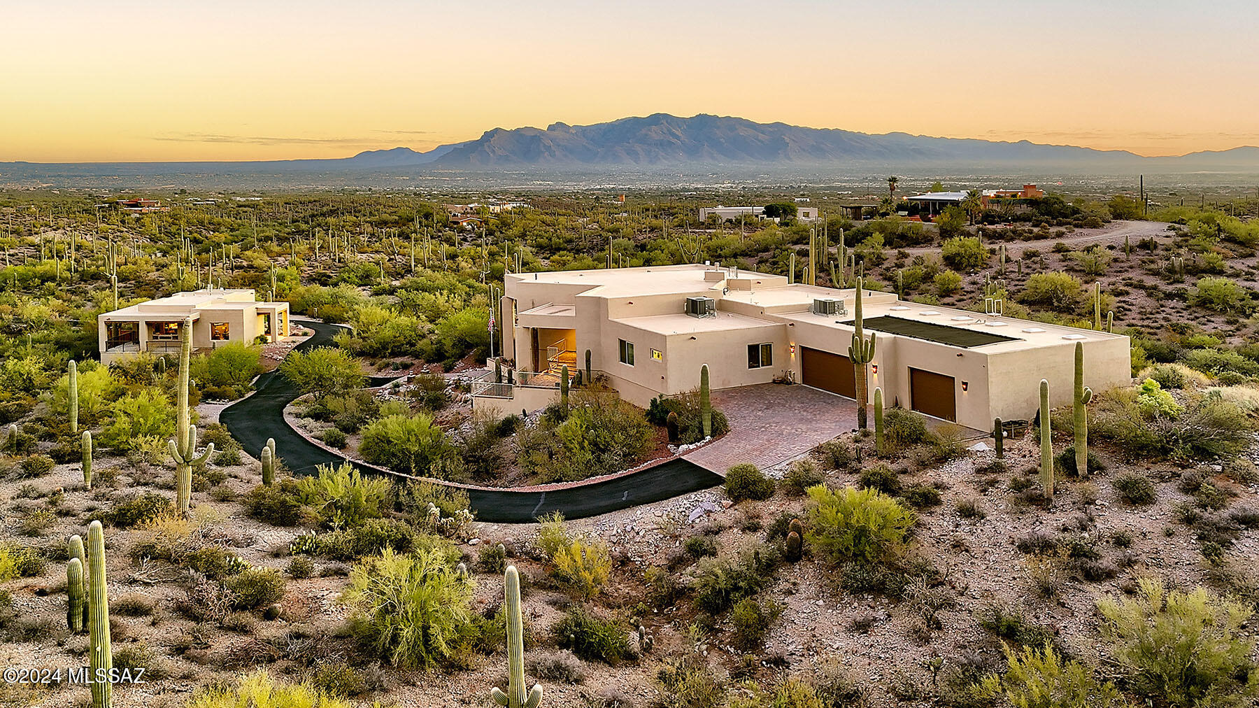 Stunning 2020 Southwestern contemporary on a glorious, saguaro-studded, 3.31-acre lot in the Tucson Mountains near Sweetwater Dr. and Camino De Oeste with sweeping Tucson city, mountain and desert views.  Featured are a separate guest home (1,109 square feet) and the main house with 3,028 sq. ft., 3 bedrooms, 2 ½ baths, no interior steps, great room/dining area with unobstructed city views, remote control gas fireplace with hand carved oak mantel and built-in sound system in great room, patio and garage.  Chef's kitchen has oversized center island with prep sink, granite counters, designer stainless steel appliances, counter level wine/beverage fridge, breakfast area and generous pantry.  Gracious 14' X 15' primary suite has over-sized walk-in closet, dual vanities, soaking tub and access to the covered patio. 1,859 sq. ft., 52' X 35 fully insulated 5-car garage has work space, storage areas, two mini-split HVAC units, 220V/50A garage wall outlet for welding or EV station.  Wonderful expansive covered patio has pool including solar roof heating panels on Pentair phone app and fire pit.  Completely furnished turn-key Casita Airbnb/guest house with parking, rents for $210/night, has great room, fully functional kitchen with center island, primary bedroom with washer/dryer, den (could be 2nd bedroom) and hot tub on lower level patio.  80 yard archery range, property zoned for horses and horse facilities and so much more.  See to appreciate.