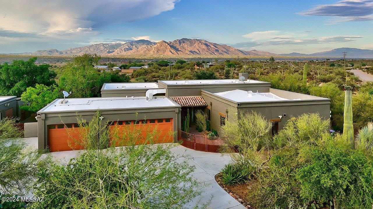 Nestled in a Serene Setting with Stunning Mountain and City Light Views, this Enchanting Property is a True Sanctuary. Discover Your Dream Home on 3.49 Sprawling Acres—A Southwestern Gem that Offers a Perfect Blend of Modern Amenities and Nature. This Remarkable 4-Bedroom, 2-Bathroom Home Spans 2,618 Square Feet and Includes a Spacious 3-Car Garage. Enjoy the Benefits of Having Your Own Private Well to Delight in this Gardener's Paradise. Immediately Adjacent to Saguaro National Park West, You'll Have Access to Miles of Scenic Hiking Trails Right at Your Doorstep. The Large Backyard with Natural Grass, Water Feature, Pergola, and Hot Tub are Perfect For Gatherings or Quiet Relaxation. Embrace the Serene Beauty and Endless Possibilities this Home Offers—Your Tranquil Desert Oasis Awaits The Property:
*Breathtaking Views: Enjoy awe-inspiring mountain and city light views.
*Nature's Neighbor: Directly next to Saguaro National Park West, ideal for nature enthusiasts.
*Hiking Trails: Explore endless trails just steps away.
*Inviting Courtyard Entry: A warm and welcoming entrance greets you.
*Circular Concrete Driveway: Adds a touch of elegance and convenience.
*Private Well: Equipped with a 1550-gallon storage tank.
*Gardener's Delight: Lush landscaping with trees, shrubs, and desert plantings.
*Drip Irrigation & Landscape Lighting: Ensures your garden stays vibrant.
*Real Grass Lawn & Water Feature: A perfect place to relax.
*Custom Pergola & Hot Tub: Ideal for outdoor entertaining.
*Storage/Workshop & Tuff Shed: Plenty of space for projects and storage.
*3-Car Garage: Includes mini-split air conditioning.
*Water Softener: For enhanced water quality.
*Covered Patio: Perfect for outdoor dining and relaxation.
*Private Yet Accessible: Secluded for peace and quiet, yet close to shopping, dining, and services.
*No HOA & Easy Freeway Access: Freedom and convenience combined.

The Home:
*Spacious Living: 2,618 square feet of beautifully designed living space.
*4 Bedrooms & 2 Bathrooms: Plenty of room for family and guests.
*Tile Flooring Throughout: Elegant and easy to maintain.
*Open Great Room Concept: Perfect for modern living.
*Inviting Foyer Entryway: Welcomes you home in style.
*Gas Fireplace: Adds warmth and ambiance.
*Updated Kitchen: Features stunning granite counters and dark wood cabinets.
*Stainless Steel Appliances: Refrigerator, dishwasher, and gas range.
*Large Island with Breakfast Bar: Ideal for casual meals and entertaining.
*Pantry Closet: Ample storage for all your kitchen needs.
*Casual Dining Area: Great for everyday meals.
*Knotty Alder Doors Throughout: Adds rustic charm.
*Large Primary Suite: Includes a walk-in closet.
*Custom Distressed Wood Barn Doors: Adds a unique touch to the primary bedroom and bathroom.
*Updated Primary Bathroom: Features dual sinks and a walk-in shower.
*Updated 2nd Bathroom: With a concrete countertop and elegant tile surround.
*Modern Fixtures: Throughout the home for a contemporary feel.

This remarkable property offers the perfect blend of natural beauty, modern amenities, and serene privacy. Welcome home to your desert oasis!