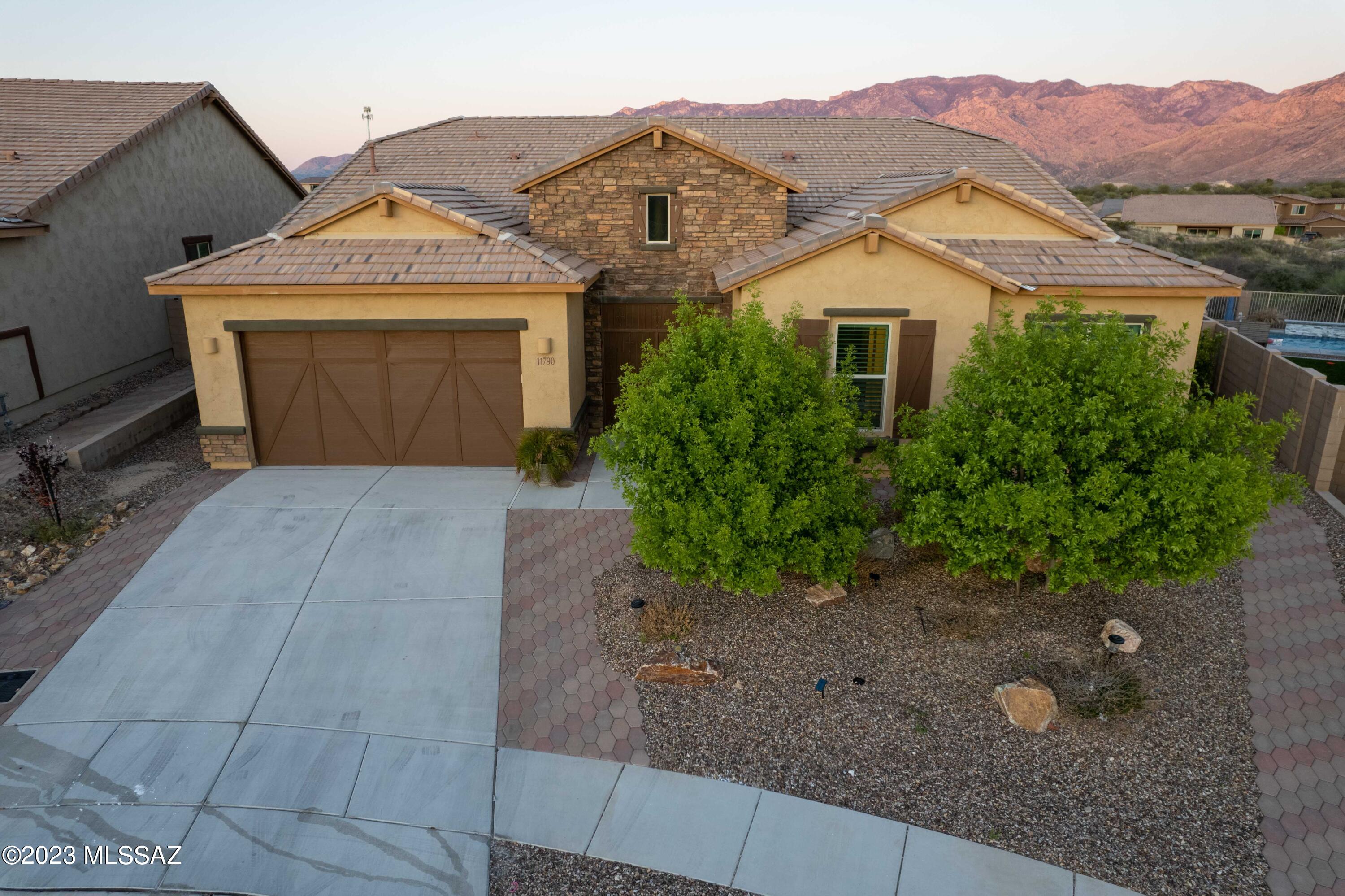 Marvelous 2020 Meritage Home in the Gated Oro Valley community of Villages at Silverhawke. This stunning home sits on a 10,411 sq ft lot that has a spectacular view of the Catalina Mountains. This 3241 sq ft home offers 5 bedrooms and 3 full baths. Multi-Slide Patio Doors open to a covered patio that welcomes you to your incredible backyard that has a fountain, pavers, fruit trees and that incredible view! Massive porcelain tiles cover the entire home, no carpeting. The Chef's Kitchen offers Gas Stovetop, Large Island and Quartz countertops. Upgraded appliances and Lighting, roomy walk-in Pantry and extended cabinets that stretch into Breakfast Nook! Primary Bedroom has En Suite Bath and door to covered back patio. Windows have Shutters and Laundry Room w/Utility Sink and many cabinets.