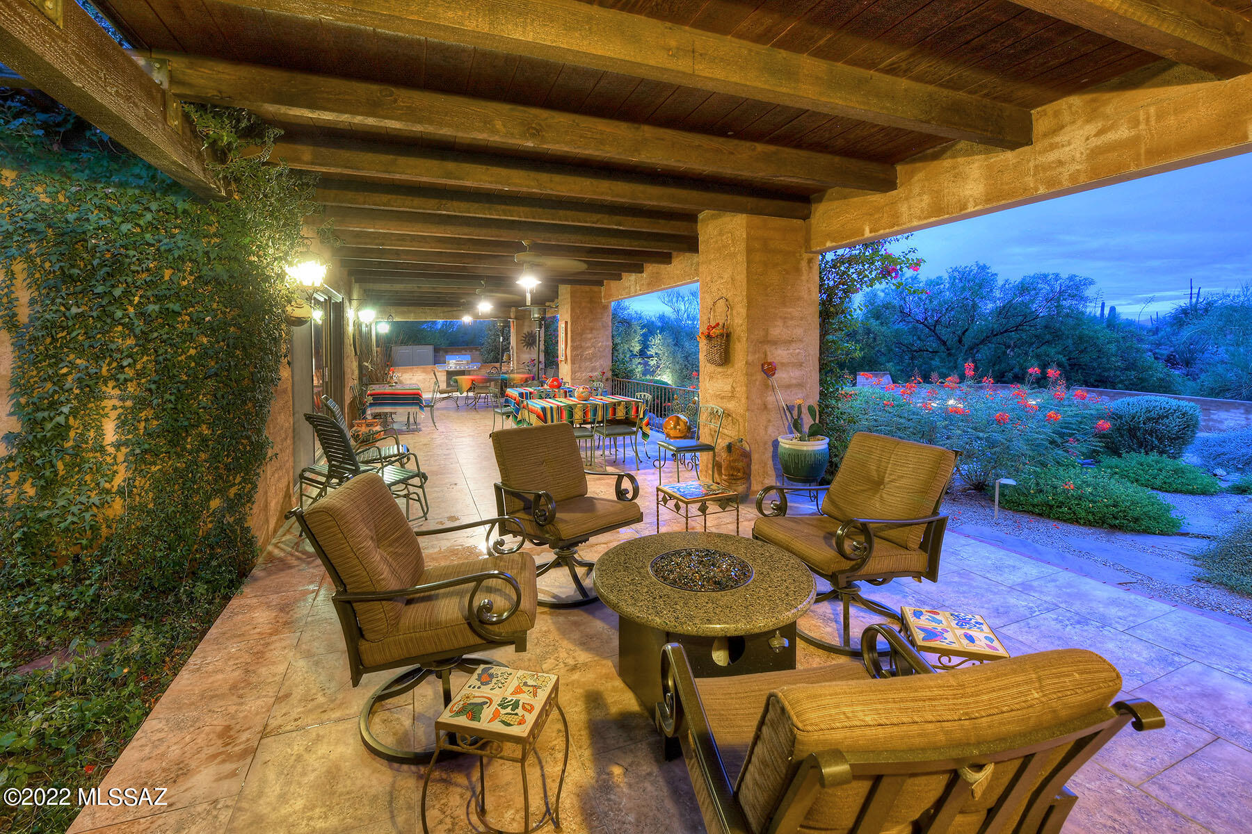 Stunning and rare Southwestern Contemporary by master architect John Campisano in Catalina Foothills Estates #7. Located on a cul-de-sac on a 1.16 acre lot with city and Catalina Mountain views, this 3,292 sq. ft., all masonry 4 bedroom home exudes authentic Tucson style and character. Covered entry leads into foyer with Saltillo tile floor to the formal dining room and views of the exterior tropical garden and koi pond. Glorious family room with fireplace and living room with fireplace have soaring, rustic beamed and planked ceiling divided by a custom-made entertainment and display cabinet and exposed block stuccoed walls. Updated kitchen features cathedral skylight, concrete overlay floor, granite counters, ceramic tile floors and dinette area with concrete overlay floors. Primary bedroom offers walk-in closet, dual vanities, spa tub and remodeled shower with river rock floor and glass block wall. Don't miss the charming rear porch with expansive covered patio with beamed and planked ceiling and BBQ. The glorious, professionally landscaped, walled rear yard oasis has pool, large artificial grass area and brick paver seating area. Two car garage and so much more.