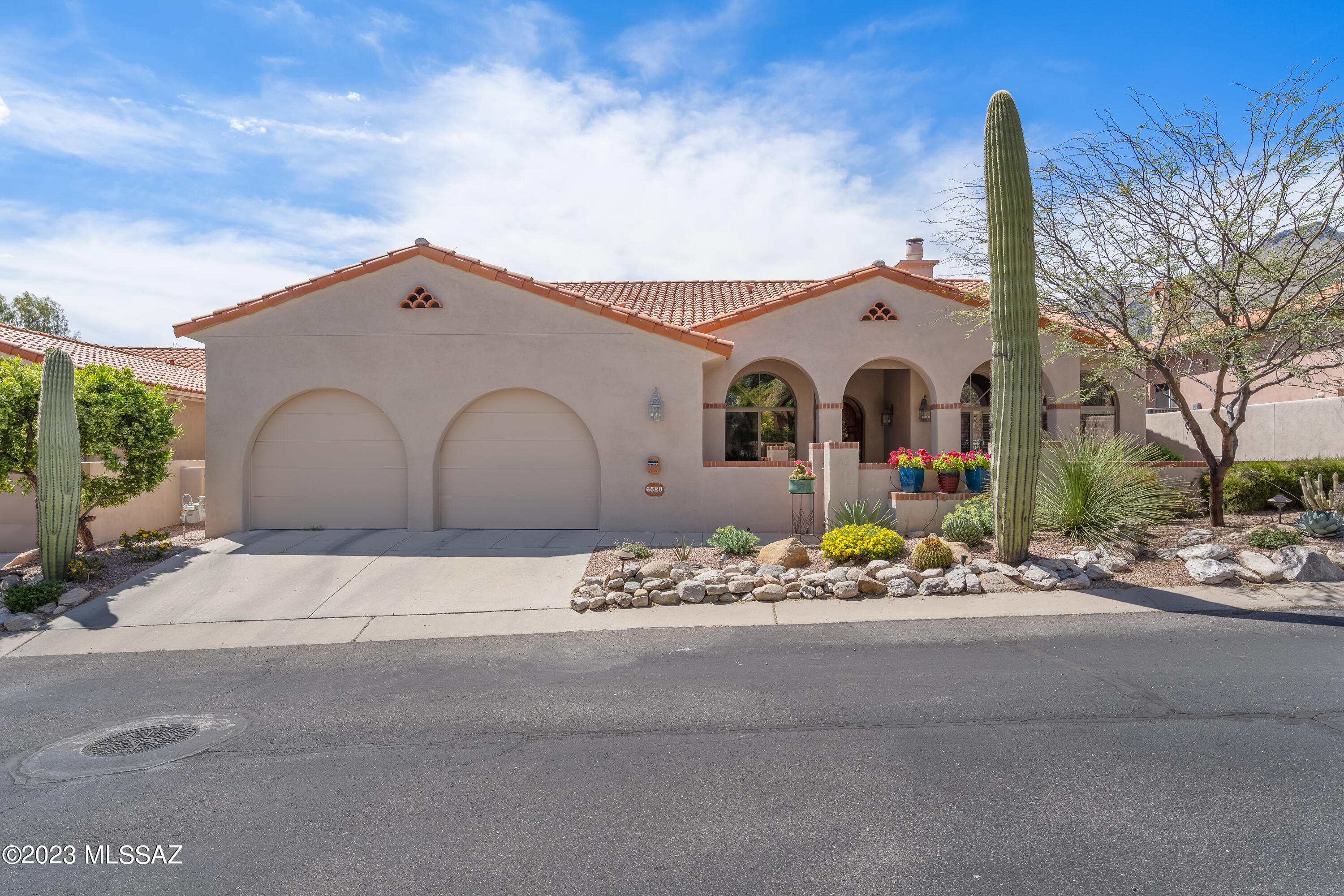 Spectacular, move-in ready home in highly sought-after Ventana Country Club Estates!  A 3-bedroom + den/office masterpiece built by David Baird!  Loaded w/upgrades & tasteful finishes!  Soaring ceilings, walls of windows, built-in niches, beautiful gourmet kitchen w/custom cabinets, granite counters, travertine backsplash, & large center island!  A stunning slate-tiled gas fireplace family room features a 1-year old large screen TV!  The master bathroom & a guest bathroom have been recently remodeled.  The home den/office features custom bookcases.  A new A/C unit in 2019, a new tankless water heater, new front & rear landscaping, new garage doors, new blinds in the guest bedrooms, two new back patio windows & screen door, & new remote controlled back porch sunshades!  Hurry, won't last!