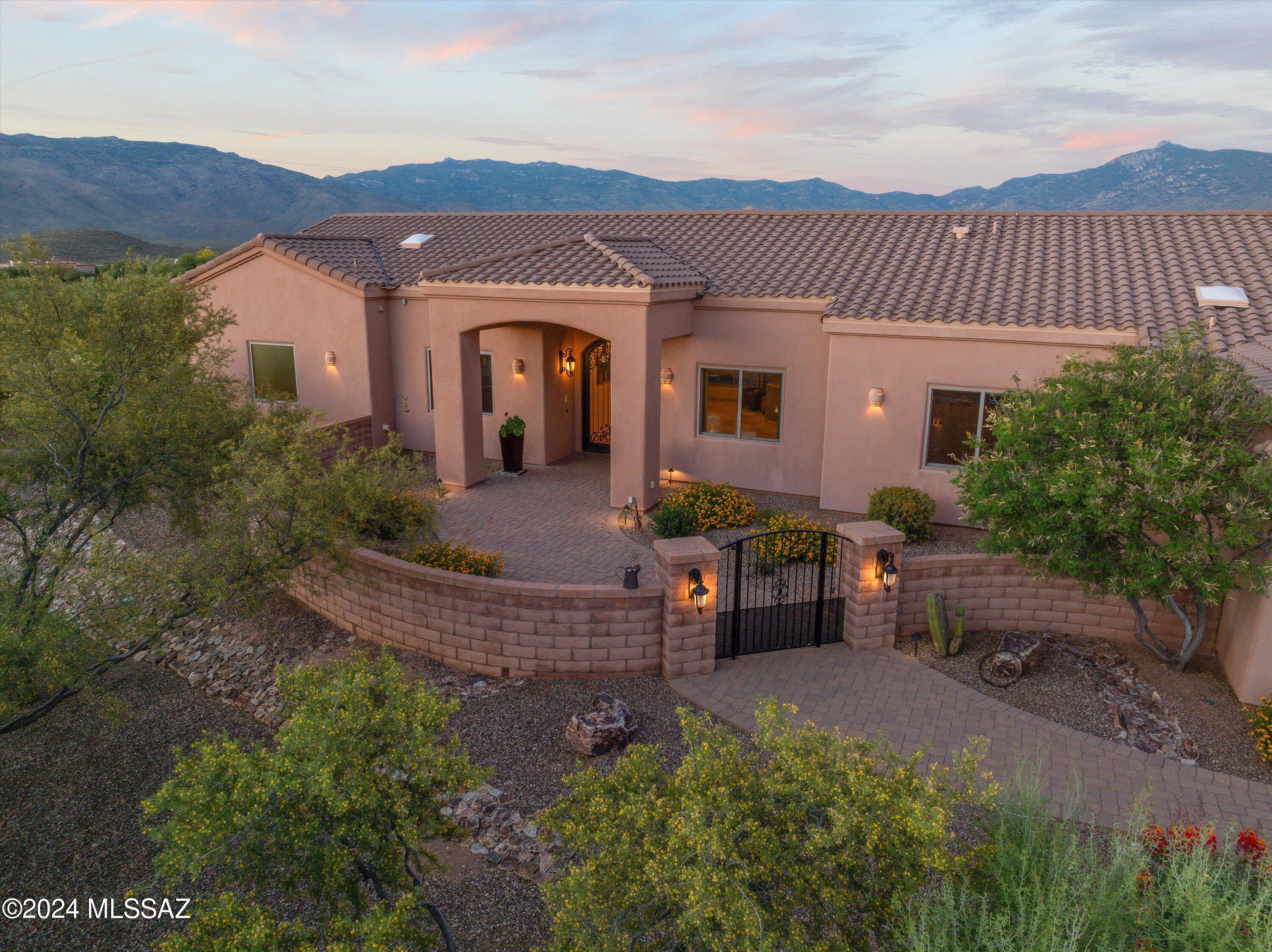 Luxury living in Coyote  Creek!  Step into this stunning home through a beautifully gated landscaped courtyard. Boasting 3 en-suites plus a versatile 4th bedroom/office, 3632 sf situated on almost 2 acres this property offers flexibility and comfort.  The kitchen is adorned with stainless steel appliances/w a gas cooktop, complemented by knotty antler wood doors and cabinetry.  Newly updated kitchen, luxurious travertine floors grace most of the house, while the upgraded Andersen window package ensures efficiency and style. Outside, indulge in al fresco dining with the outdoor BBQ/patio kitchen, or bask in the solar-heated salt water pool & spa. Oversized 3 car garage/workshop with additional storage. This home promises year-round comfort.
