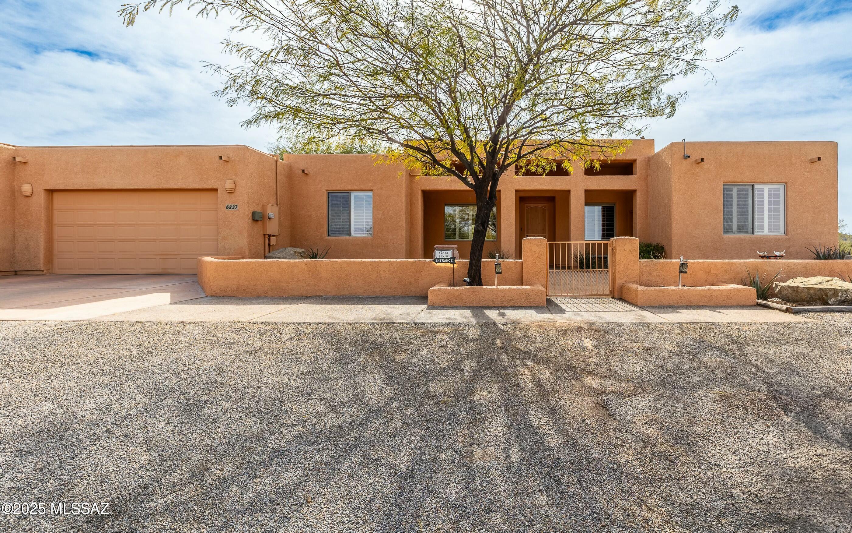 What a property!  Rare find for this almost 7 acres homesite w/main house, guest casita/house w/own kitchen & laundry, massive RV garage that can hold a Class A + many more toys!, Pool, screened in patio w/hot tub, sand volleyball, lovely walled in private entertainment backyard w/beautiful night scape lighting. Zoned horse property.  Minimum of 6 vehicle parking garage space - probably more! Room to store everything!  Workshop area, enclosed RV parking & plenty of exterior spaces. Some much extra land for perhaps horses or other dwellings. Unlimited opportunities. Single story - no steps. Southwest charm throughout.  Private w/beautiful mountain views & city lights. Stunning property.