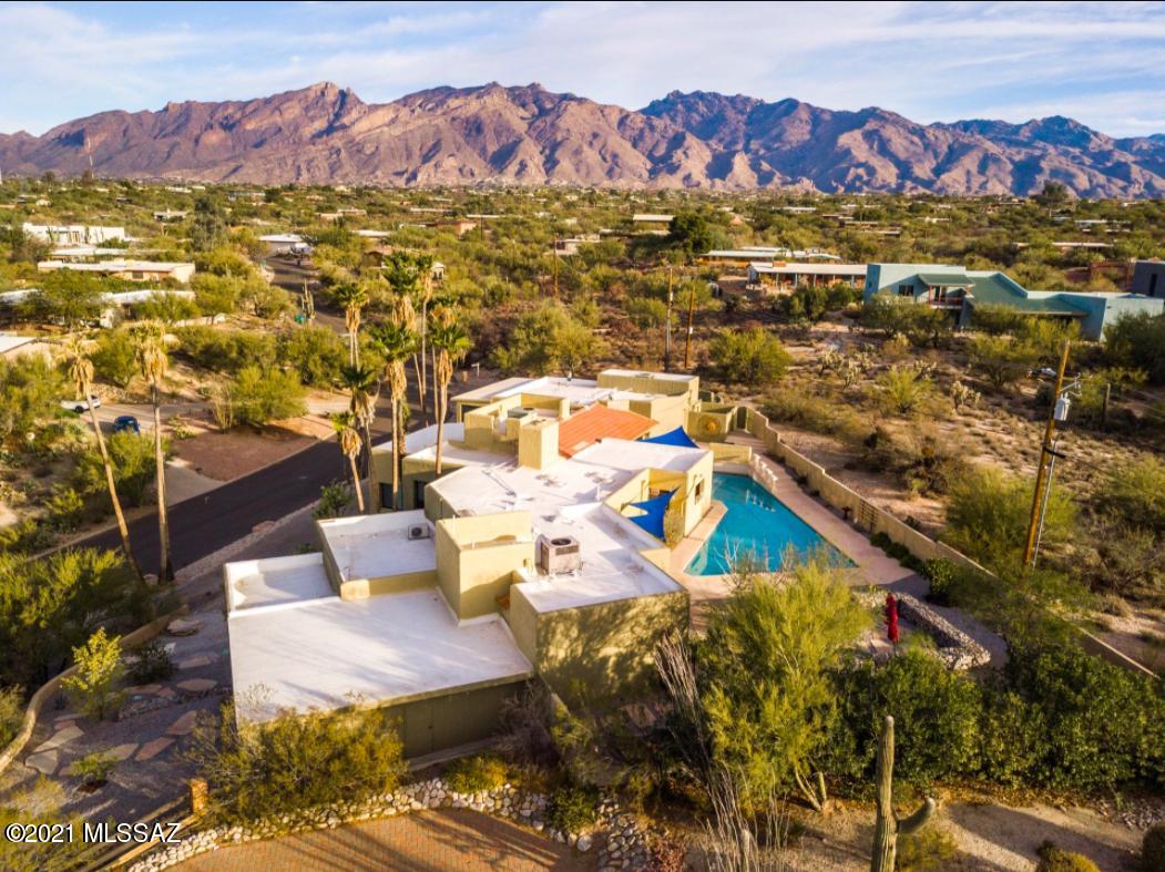 Custom home w/mountain & city views nestled high on the ridge in desirable 85718 zip code! Your personal sanctuary unfolds as you enter from the circular drive. Exquisite design & elegant features t/out incl. steam room, see-through fireplace, tons of natural light & views from every window! New in 2020: HVAC units, H2O heater, roof just re-coated (with 2-year warranty) & exterior freshly painted! Plus all updated dual-pane windows! Kitchen is perfection w/rich cabinetry, Sub-Zero refrigerator, double ovens, stone counters & breakfast bar. Oversized owner's suite boasts fireplace, exercise room & luxurious bath w/dual vanities, steam room, separate shower & jetted tub. Two-bedroom guest wing + downstairs guest quarters. Private backyard oasis complete w/pool, BBQ & breathtaking views!