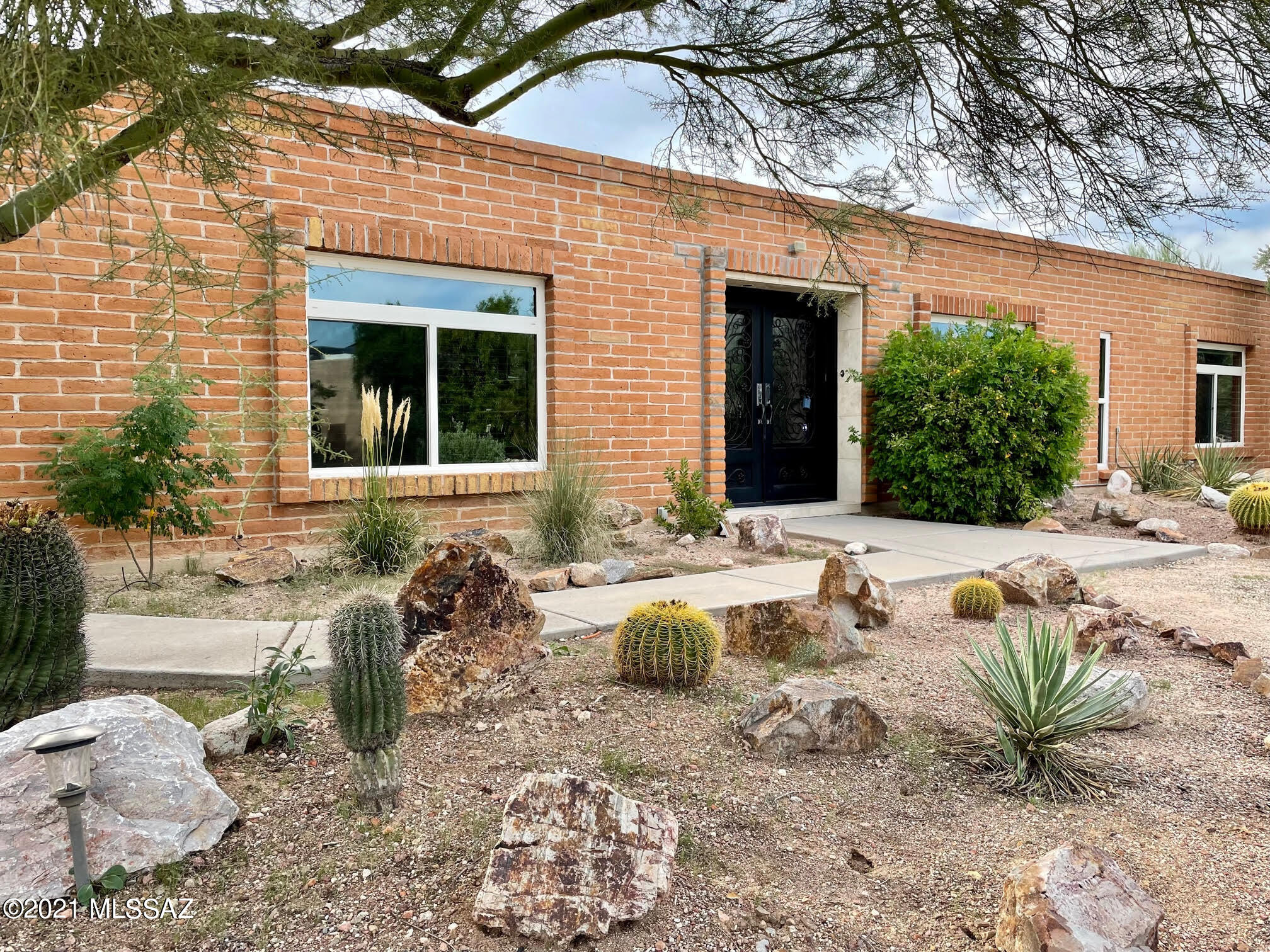 Enjoy privacy and panoramic mountain views from this sprawling, nearly one acre property in the Catalina Foothills. Splash in the large pool or capture sunsets from the expansive porch. The spacious gourmet kitchen is equipped with a 6 burner gas cooking, large center island, and both butcher block & granite counters. An enormous butler's pantry has a second sink, dishwasher, and refrigerator with even more counter space and storage. Entertain in the living room with fireplace, large bonus room with built-ins, or dining area with sliding door to the back yard. The primary suite has an elegant bathroom and access to the pool and hot tub. Three additional bedrooms and a second updated bathroom complete this exceptionally functional home.