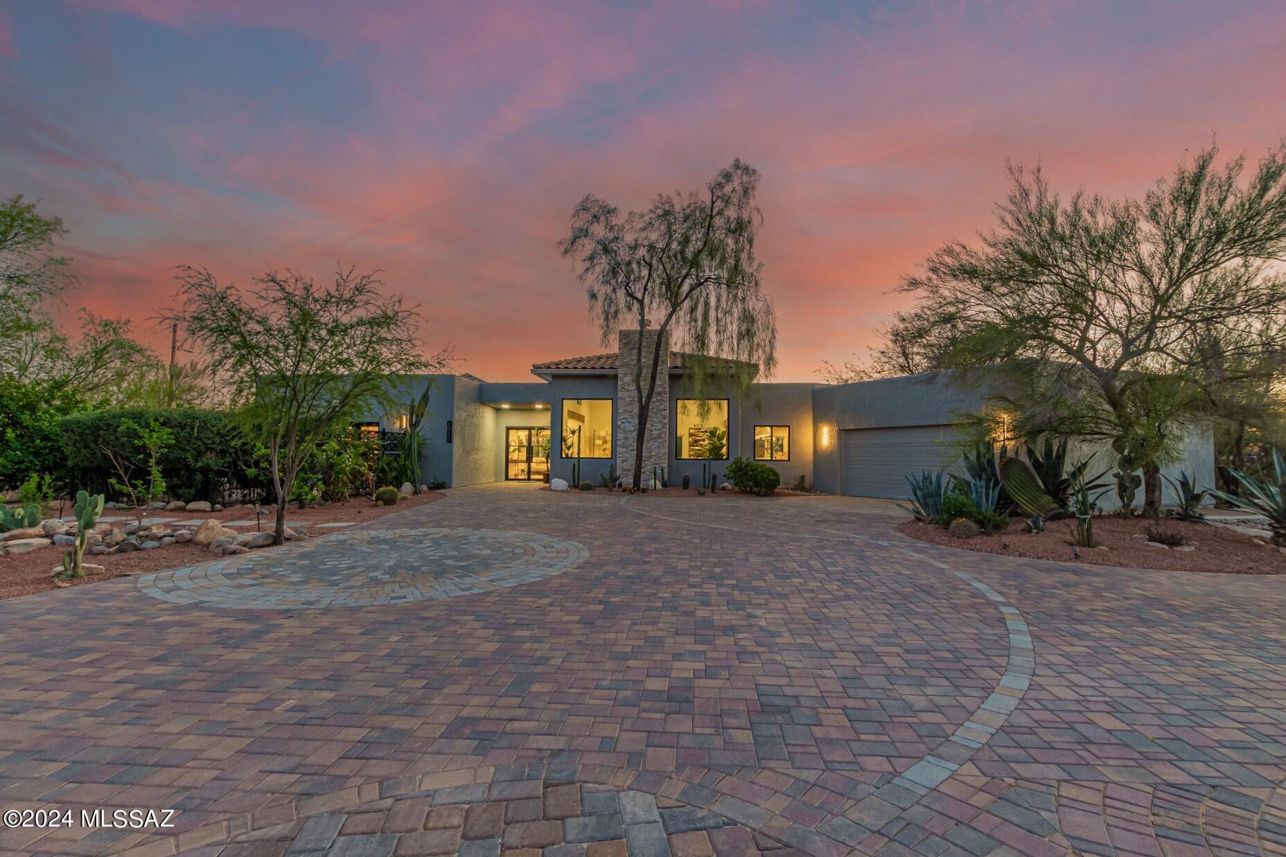 ABSOLUTELY IMMACULATE FULLY RENOVATED GORGEOUS HOME. Panoramic mountain views from everywhere! EXTREME PRIVACY at end of cul-de-sac. Separate self-sufficient GUEST HOUSE (full kitchen, bath, laundry, walk-in closet, private courtyard & entry). OWNED solar. Pebble Tech Pool and Spa. Gourmet custom kitchen with gigantic island, wet bar. LUSH vegetation and your own private desert trail. Wide open floor plan. FOURTEEN foot living rm ceilings with fireplace and 8ft windows framing the mountains. 3,462sf under roof. 4BRs/3BAs. SIX separate outdoor sitting areas - all with extreme privacy. Convenient North Tucson location. No HOA.