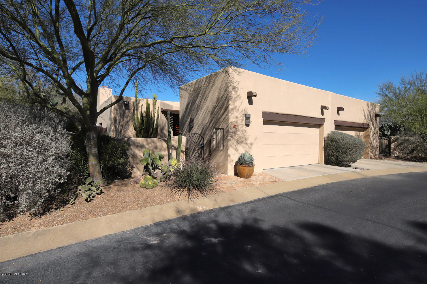 Located in the highly sought after Old Fort Lowell District, homes rarely hit the market in La Sonrisa! This inviting Santa Fe town home features lovely courtyard entry, open kitchen with granite counters, stainless steel appliances, gorgeous beamed ceilings and saltillo floors, master bath with dual shower heads and dual sinks, guest bedroom with built in shelving and 2 windows that let in the natural light. Family room with wood burning fireplace and french doors that lead to peaceful patio space with desert plantings and water feature. Separate 2 car garage and community pool & spa! The owners have truly enjoyed living in this private, well-kept neighborhood!