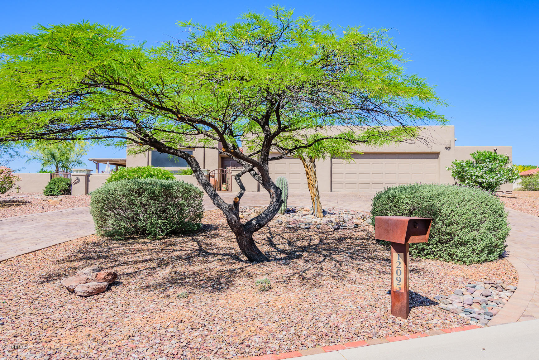 Custom built Sante Fe charmer with panoramic Catalina Mountain Views on nearly half an acre! Plenty of room for everyone in this one of a kind, 5 bed, 3 bath, 2897 sqft home. Completely updated throughout with tile flooring in all the right places & plush carpeting in the bdrms. Open floor plan concept, soaring ceilings, & a kitchen that opens to the great room with a spectacular handmade rock fireplace. The kitchen offers unique custom build cabinetry & rich granite countertops. See the amazing mountain view from the formal dining & living room. You will love to entertain in the beautiful & private backyard.. complete with a lap pool, built in bbq, extensive wrap around covered patio, & take in those mountain views! Plenty of parking space with the 3 car garage. Paver driveway, courtyard, & patio add an eye-catching upgraded touch. Stylish, custom-made, exterior wrought iron security doors complete the look. Agent is related to Seller.