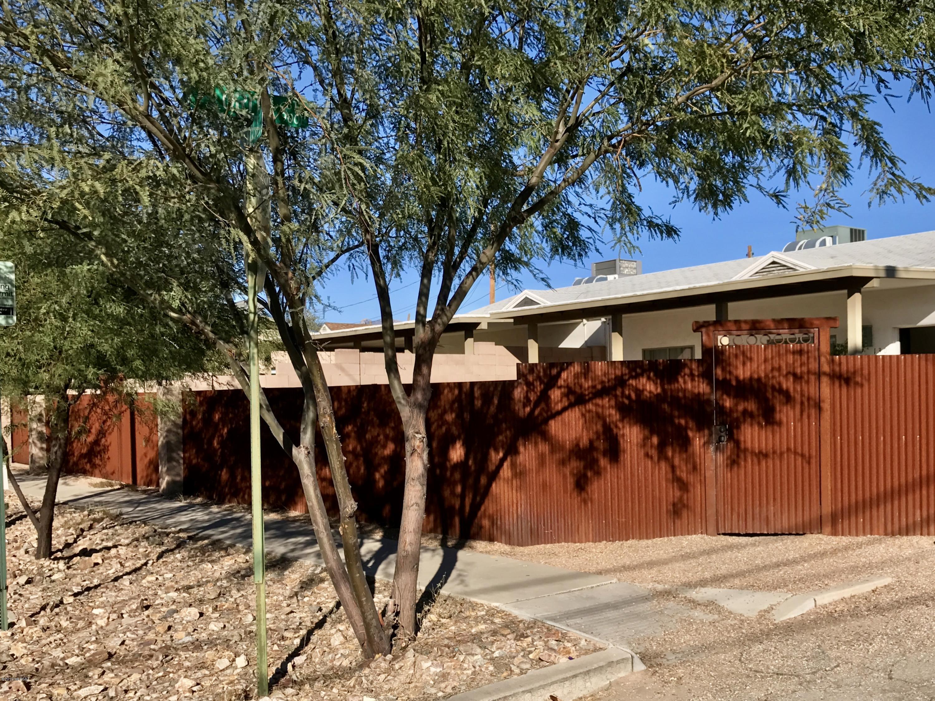 This beautiful home has everything you could want for Tucson city living. Less than a half-mile to the U of A and less than a mile to Downtown, 4th Ave, and the light rail. Perfect for a multi-generational family or someone who wants to live in one unit and rent the other to pay a chunk of the mortgage. Both units have been painstakingly remodeled with upgraded insulation, dual pane windows, gorgeous tile backsplashes in the kitchens and baths and over 1500sf of covered porch for outdoor living, and a large custom-built shed with outlets for all your power tools. Low care landscaping with Lemon, Grapefruit, Lime, two varieties of Peach trees, mature desert trees for shade and desert wildflowers throughout the property. Trellis and vines atop the block walls add loads of privacy and natural beauty to the large enclosed back yard. Ceiling fans in every bedroom. New roof in 2018 with 5 year labor and materials warranty. Smart thermostats and Smart Smoke & CO detectors give you peace of mind and easy programmability when you are away from home. 3 bedroom unit was a vacation rental that grossed over $30,000 in the first year. Proximity to the University & Downtown kept this stunner rented year round with guests from all over the world. Sellers' work/travel schedules this year have kept them too busy so they've decided to sell. Don't miss your chance to live the good life. Owner/Agent.