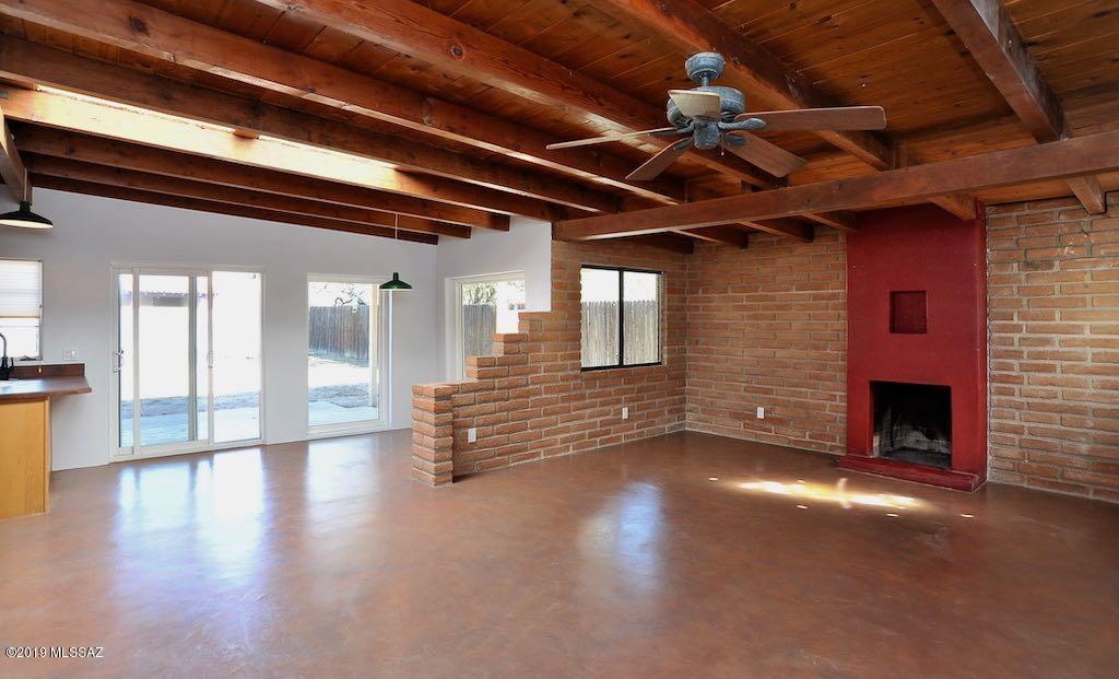 Unique 3 Bedroom 2 Bath Midtown home just 1.5 miles to UofA in sought after Jefferson Park. 1618 square feet. Recent floor to ceiling remodel includes: Concrete floors, new paint, texture, fixtures, ceiling fans and blinds. Big great room has vaulted wood beam ceilings, fireplace, lots of exposed adobe brick, big windows and skylights that create tons of natural light. Spacious kitchen with gas stove, built in wine rack, lots of maple cabinetry and counter space. All 3 bedrooms have wood beam ceilings and concrete floors. Laundry room comes with full-size washer/dryer and some interior storage space. Big fenced yard has covered patio, alley access and large outdoor storage shed. Ceiling fans in all rooms and Central A/C and Heat. No Pets will be considered unless they are Service or ESA Animals. This home is offered as NON-SMOKING. PLEASE NOTE: INTERESTED APPLICANTS MUST BE WILLING TO OCCUPY PROPERTY WITHIN 30 DAYS.