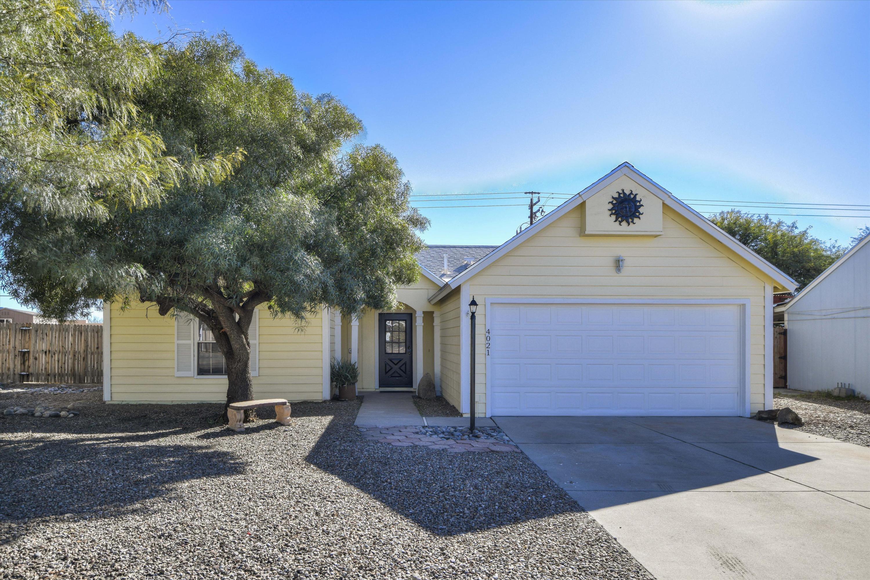 Adorable 3 bedroom, 2 full bath in Cortaro Ridge. Newly painted inside and out; immaculate. Fantastic great room with working fireplace, red brick seating on each side. Kitchen with all black appliances, gas stove, French door refrigerator, Bosch dishwasher. Cute front yard, drive through gate to backyard. Roof, AC and polybutylene pipes all replaced within last 8 years. HUGE backyard, great mountain views from lovely covered patio. Yard large enough for future pool, block wall enclosed. 10 x 12 wooden storage shed. Work bench with cabinets in garage