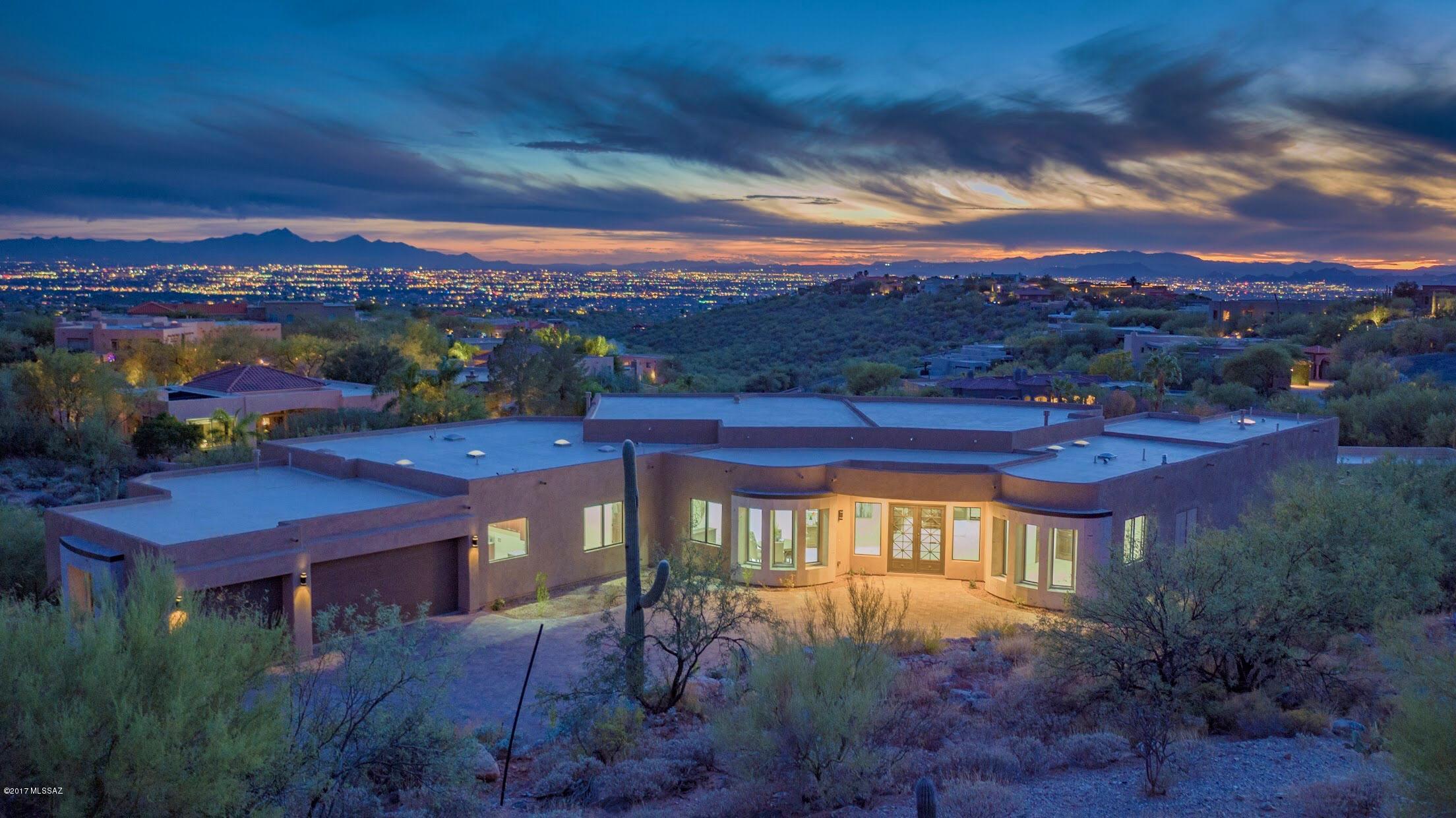 BRAND NEW CONTEMPORARY HOME. BREATHTAKING CITY VIEWS INSTANTLY STRIKING UPON ENTRY, LOCATED IN PRESTIGIOUS FOOTHILLS AREA OF ALTA VISTA. CUSTOM WROUGHT IRON/GLASS ENTRY DOORS, BEAUTIFULLY BALANCED COMBO OF CANTERA STONE, GRANITE & MARBLE THROUGHOUT, SILVER QUARTZITE FIREPLACES IN MASTER, LIVING & FAMILY. FORMAL DINING, VAST GOURMET KITCHEN ISLAND, VIKING APPLIANCES, GAS RANGE, 2 DISHWASHERS, REFRIGERATOR, BREAKFAST AREA, 8FT. DOORS, 5 BEDROOMS EACH W/ THEIR OWN BATHS & WALK-IN CLOSETS. MASTER W/ LUXURY BATH, JACUZZI TUB, & PRIVATE ENTRY TO REAR PATIO. ENJOY BKYD W/POOL, SPA, COV'D BRICK PATIO, BBQ, 3 CAR GARAGE, BRICK PAVER DRIVEWAY & DIST.16 SCHOOLS! FLOOR PLAN UNDER PHOTOS/VIRTUAL TOUR. SELLER IS LICENSED REALTOR IN STATE OF ARIZONA.