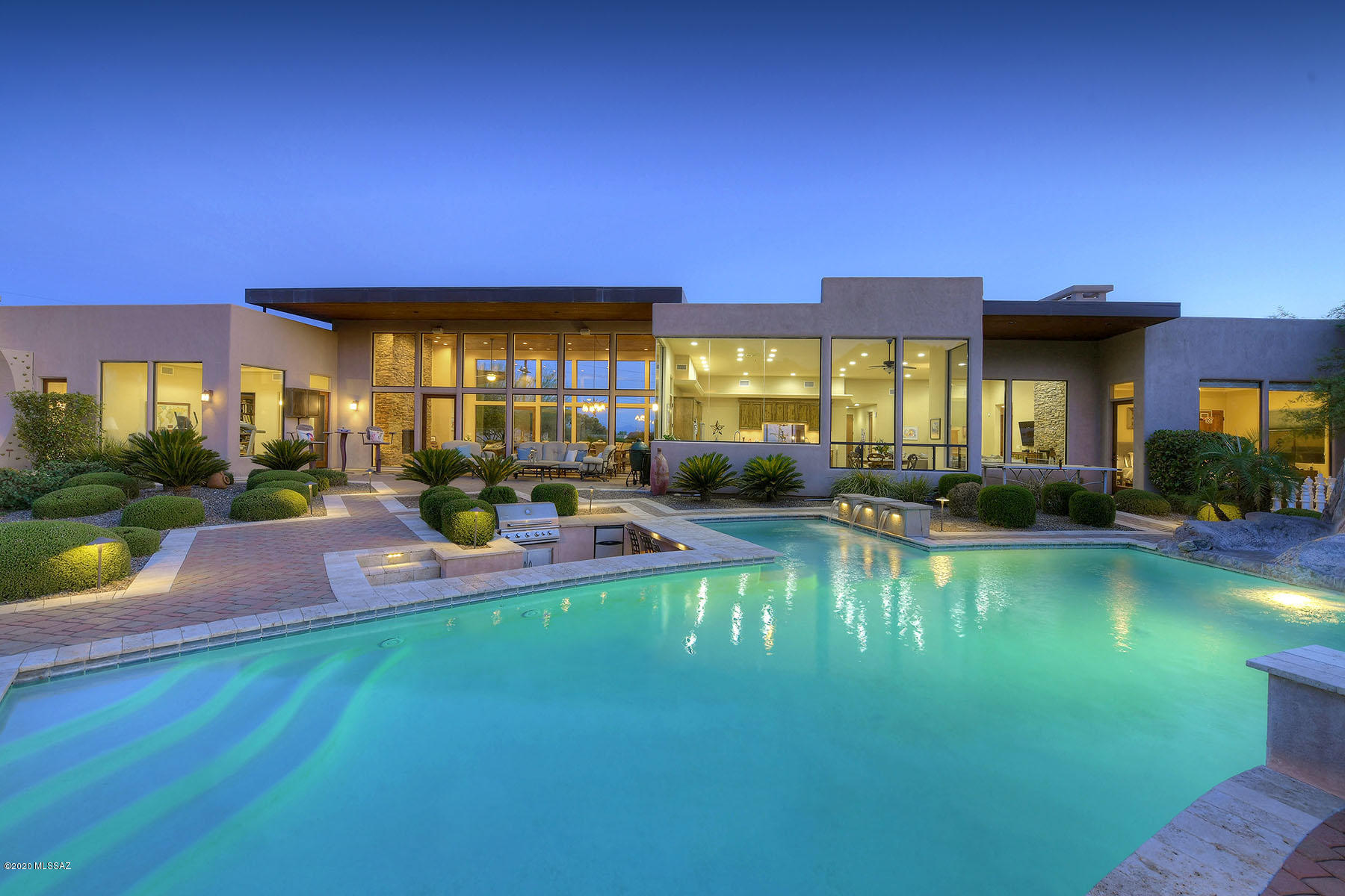 Incredibly dramatic soft contemporary style home w/magnificent mtn & city views situated on 1.3 acre homesite high on a hill in the Catalina Foothills. Exquisite living rm  & dining rm w/14 ft. high floor to ceiling windows, beautiful 
stacked stone fireplace, gourmet island kit w/granite countertops, Viking stainless steel appliances, gas stove top, refrigerator, pantry, bkst  area opens to family rm w/fireplace, travertine tile flrs,  5BR's (split plan) ,6 BA's, billiard rm w/wood flrs, temp. controlled wine
rm + playroom or computer rm w/ guest qtrs kitchenette, laundry  rm & 3 car gar. Resort like backyd w/patio, amazing custom pool, spa, slide,
swim up bar, BBQ, grass play area, lush landscaping , Dist. 16 & mtn views. What more could you want! 3D tour under photos/virtual tour.