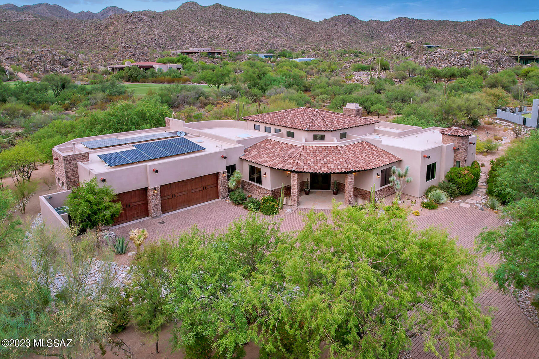 Exquisite Tuscan estate in the prestigious golf community of Stone Canyon boasts solar energy, smart home system plus mountain/sunset views. Stately 3BD/4BA (4,100 SF) home with office sits on private acre lot off Fairway #13 with brick paver drive, wrought iron entry door and stacked stone facade. Soaring ceilings, natural stone floors, rounded walls & windows plus skylights add to the ambiance. Formal living/dining rooms flow to gathering room with wet bar, gas FP and floor-to-ceiling view windows. Gourmet island kitchen boasts luxury appliances plus breakfast bar & nook. Private Owner's suite hosts dual vanities, jetted tub, walk-in shower, divided closet. Two en-suite guest rooms. Dine on the rear flagstone patio w/outdoor kitchen or enjoy the pool/spa and putting green. A must see!