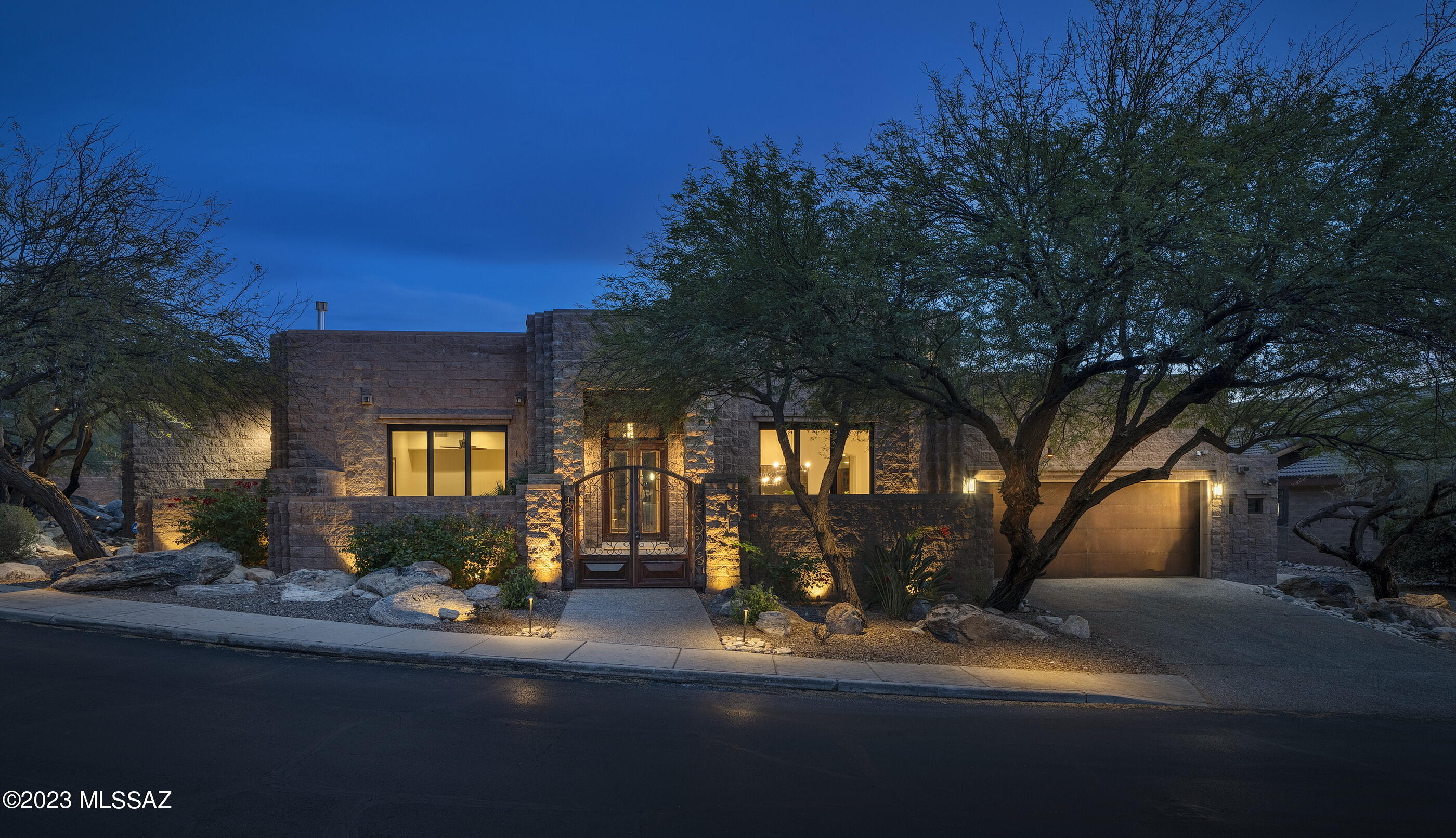 Set on a private golf course lot in Ventana Canyon, this meticulously updated masonry block home features 5 bedrooms and 4 bathrooms + an office/den, and a 2 car garage with separate golf cart garage. Enter this sophisticated residence through a gated private courtyard and into the lofty foyer entryway. The entrance flows into a formal dining room, featuring floor to ceiling sliding glass doors that open to a private patio area. The updated kitchen offers crisp white quartz countertops, a pro-level stainless steel appliance package, built-in Wolf coffee system, wine fridge, and warm Maple cabinetry. Stunning 24'' X 24'' travertine tile flows through the home, with plush carpet in the bedrooms, and solid Maple doors. The primary suite is located on the first floor, complete with private patio access, and a spa-like bathroom with a freestanding tub and separate rain shower. An additional 2 bedrooms are located on the primary level, each being a generously sized light-filled room. The second floor offers 2 more guest bedrooms, a beautiful bathroom with dual vanities and walk-in shower, and a private balcony with exterior spiral staircase, offering sensational mountain and golf course views. 

Meticulously incorporated updates to the home include: newer windows and doors, motorized Hunter Douglas shades, a 72" Mezzo linear fireplace, carpet, paint, baseboards, lighting, security system, and thoughtfully placed landscape lighting. 

Seamless indoor-outdoor entertaining connects the shared living spaces, with a series of doors coordinated to tie the interior rooms to the spacious outdoor living environments. Walkways meander through the lush grounds, leading to a stone fireplace with sitting area; the result being a home that offers a sense of ease to enjoy the Arizona lifestyle.

Ultra-privacy meets convenient proximity to all of life's necessities. Just moments away from hiking and biking trails, shops and restaurants, as well as the exclusive Ventana Country Club, offering 36-holes of championship golf, an elite tennis program, a resort and a lap swimming pool, and features a members clubhouse with dining and lodging for member's guests.