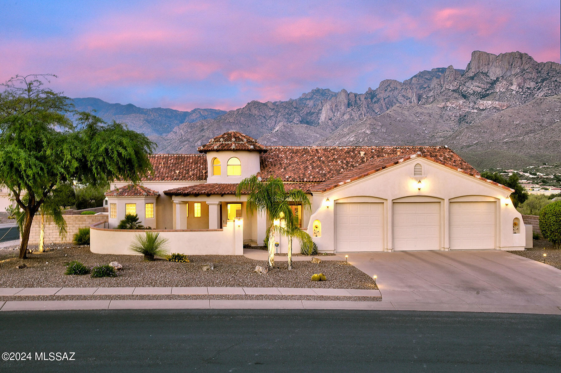 Welcome to your dream home in Pusch Ridge Vistas II. This stunning 2,820 sq ft residence, situated on a spacious .38-acre lot, offers an elegant blend of comfort & luxury. Located in a fabulous, gated community with breathtaking Catalina Mountain views. 3-bedroom, 3-bathroom split-bedroom plan home backs up to a serene desert common area, ensuring ultimate privacy. As you step through the unique arched front door into the round foyer with clerestory windows, you'll be captivated by the light-filled atmosphere. The formal dining room, perfect for family gatherings, boasts exposed beam & plank ceilings. The expansive great room, with its six windows arrayed in a gentle arch, provides a stunning view of the mountains & is ideal for relaxing by the fire or enjoying TV.  See the MORE TAB The open-concept design seamlessly connects the great room with the kitchen, breakfast nook & bar creating a harmonious flow. The chef's kitchen features two ovens, a 5-burner gas cooktop on the island, downdraft vent, solid wood cabinets, built-in microwave, & breakfast bar for five. The luxurious primary bedroom offers five large windows and backyard access, while the en-suite bathroom showcases a stone tile dual vanity, soaking tub, no-step stone shower, gas fireplace, and privacy-enhancing glass brick. The spacious guest bedrooms share a bathroom, as finely appointed as the primary. Practicality meets convenience in the well-appointed laundry room with ample storage & large utility sink. The three-car garage includes attached cabinets and overhead storage racks for optimal organization. The covered back patio adorned with pavers, leading to a meticulously landscaped yard with gas fire pit, spa, micro pebble tec pool with a waterfall, and, of course, the spectacular views. This exceptional home combines luxury, comfort, & breathtaking surroundings. Don't miss the chance to make it yours!