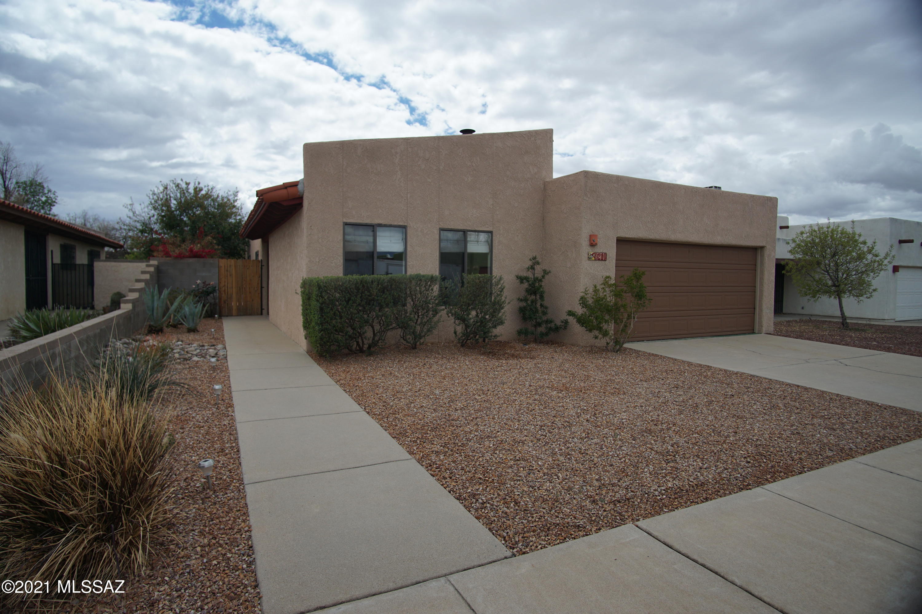 Ready to move in and enjoy! Beautiful French doors lead to wonderful outdoor retreat. Natural fence and trees provide lots of privacy. Outdoor grill on natural gas! Freshly painted, new microwave/stove, cleaned & polished concrete/tile floors, and new carpet. Gorgeous remodeled master bath. Truly a ''home sweet home!''
