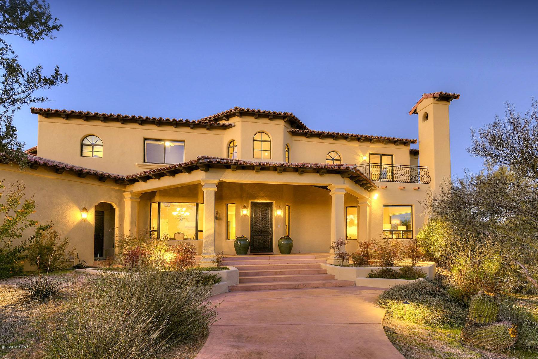 Majestic Spanish Colonial designed by Ron Robinette & built by Jim Luckow Construction. This Rastra built home features the highest quality materials, impeccable craftsmanship & many energy efficient benefits. It's stunning presence as you enter the long private drive leaves little to be desired. Main level includes your day to day spaces w/tremendous great room, formal dining, living room w/grand FP & guest room w/full bath. Inviting kitchen has large island, double ovens, multitude of cabinets & eat-in area. Upstairs Master suite shares luxurious bath, generous walk-in closet & private balcony w/hot tub. Guests will love the almost 900 sqft downstairs basement perfect for a media, craft or game room. Entertain year round in the backyard featuring pool, ramada, FP & mountain views.