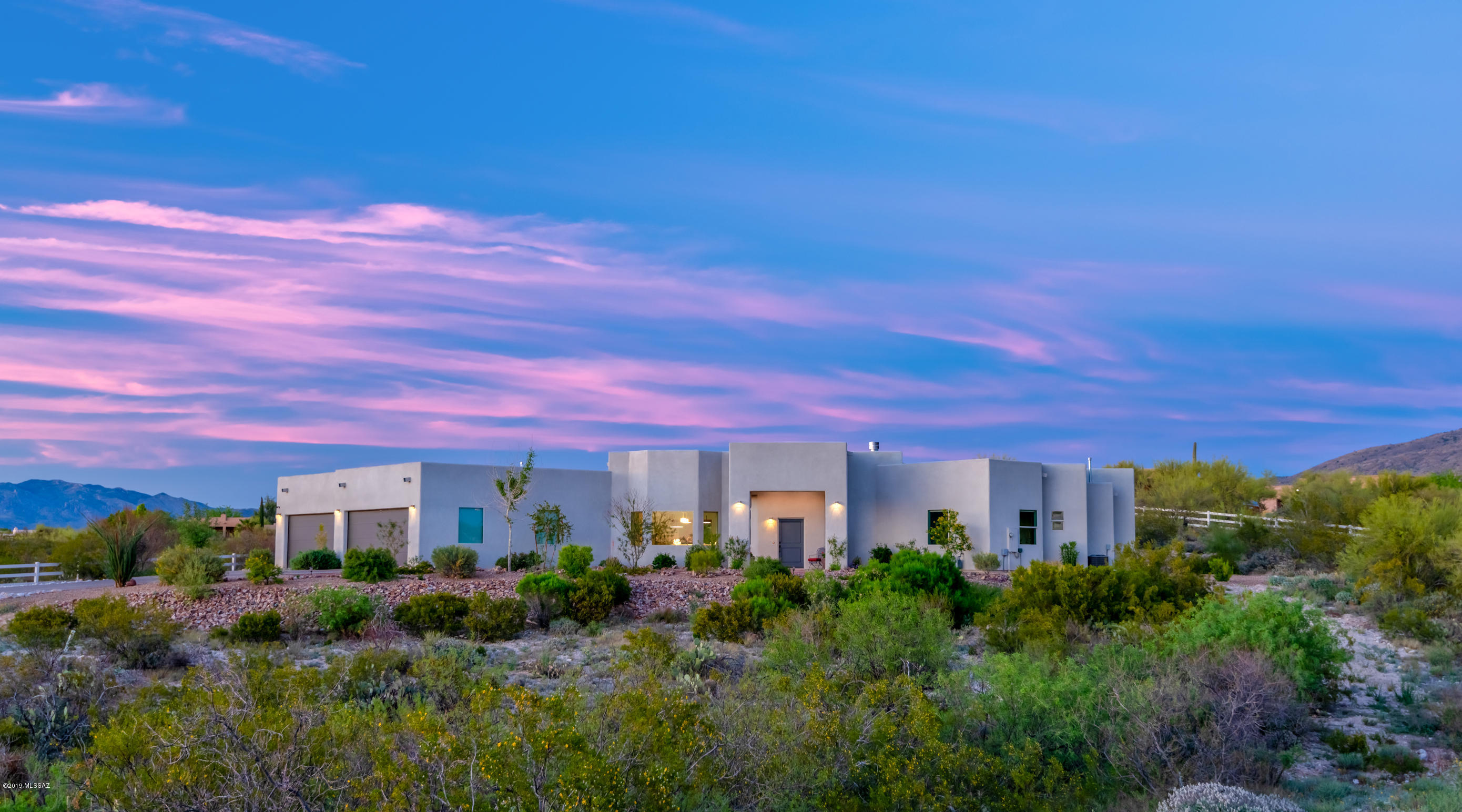 New construction in 2017!!  Meticulously maintained custom home located within Manning Camp Enclave, a cozy gated community at the base of Saguaro National Monument East. This new, contemporary gem has it all...fully fenced 3.6 ac of horse property with panoramic views of all mountain ranges, resulting in spectacular sunrises and sunsets. The spacious, clean-lined living areas, open kitchen w/quartz and granite countertops, gas cooktop w/griddle and pot filler, double wall ovens, warming drawer, built-in all refrigerator/all freezer, 2 dishwashers, ice maker, fabulous polished concrete flooring throughout the entire home and into the 4-5 car garage, 4 fireplaces, >90% led lighting, soaring ceilings, wet bar w/wine and beverage refrigerators, Master bedroom retreat w/office (Flex room), Gorgeous spa bathroom w/walk-in rain shower, emphasize the state-of-the-art design of this home. Spacious living areas seamlessly transition to an extraordinary undercover, outdoor kitchen and entertainment area. Beautifully landscaped and fully irrigated low maintenance yard, leaves you free to enjoy the plethora of activities Tucson has to offer!