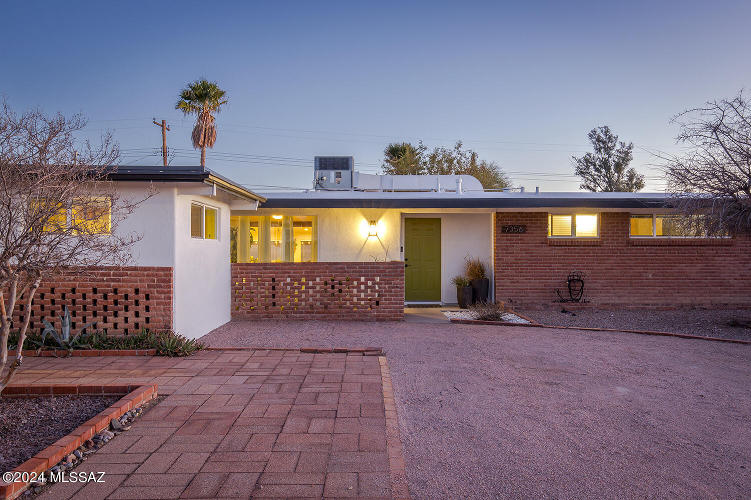 Step inside this well cared for mid-century ranch style home in a quaint Eastside neighborhood. Updated with carefully considered designer touches throughout. This spacious home provides a main living area that consists of a great room, breakfast bar, off-kitchen sitting area and a proper dining room. Just off the great room is another special bonus or Arizona style room with lots of light and windows that look out to the manicured backyard. The home has a nice flow that leads into three bedrooms and two full bathrooms on the westside and another room that could be used as a bedroom or an office, studio or workout room. Whatever suits your specific vision or needs as a buyer.