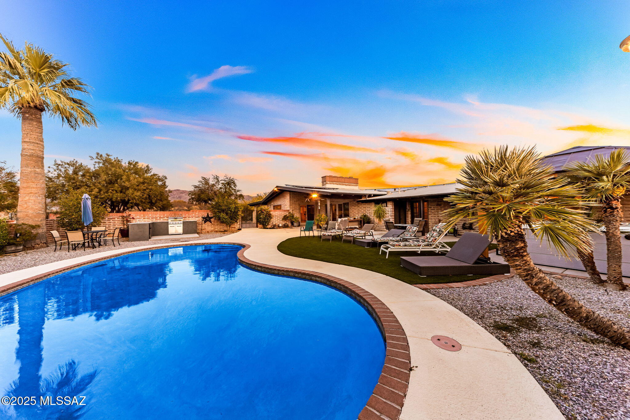 Range Priced-Seller will accept/or counter offers b/w $895,000 to $925,000. Gorgeous 4bed/3 bath Ranch on 3.4 acres with Panoramic Views of the Rincons & Catalinas & 3 miles from Saguaro National Park. Views, Desert & Relaxation in this Secluded Estate. Deluxe Dual Primary Suites w/ private exterior entrances, upgraded bathrooms, multiple closets, view windows & Ceramic Tile throughout. The backyard ''resort-like'' oasis showcases a Pool, 8-person Spa, Built in BBQ, large covered Patio & Turf. Horse facilities have an arena & corral, tack room, elect/water. PLUS-SOLAR for low utilities. Every inch of this home has been modernized or upgraded from electrical, plumbing, water/gas lines, bathrooms, kitchen, flooring, garage, lighting, appliances, roof & HW tanks. Fall-In-Love Today! No HOA. Entire Property is fenced. Dual driveway entrances are gated & there is plenty of parking! Includes a graded RV/Trailer pad with a 50 amp installed, easy to convert to RV hookup. Newer 200 amp electrical panel plus sub panel on home. Solar system is leased with $289 monthly payments. 41 panels and 12,000 kw production. Gas appliances and fireplace in home. 2 hot water tanks, one gas/tankless servicing two bathrooms on west side of home, one electric 40 gallon in garage storeroom area servicing laundry room, kitchen and two additional bathrooms. Three electric 1 ton min-splits in home, not necessary but installed, two of which are less than one year. Pool can be heated, gas line and heater disconnected and never used by current owner. Water and Electric at Horse barn. 2 stalls with runs, 2 stalls and tack room inside barn, one additional hay shed, arena, corral and fully fenced. Newer water lines from main at street to home installed with filter at main. Newer gas lines from main to all appliances in home. Newer septic main line and cleanouts. Septic pumped and certified April 2024. See maintenance and upgrades list in documents. All appliances and some furniture may convey with accepted offer.