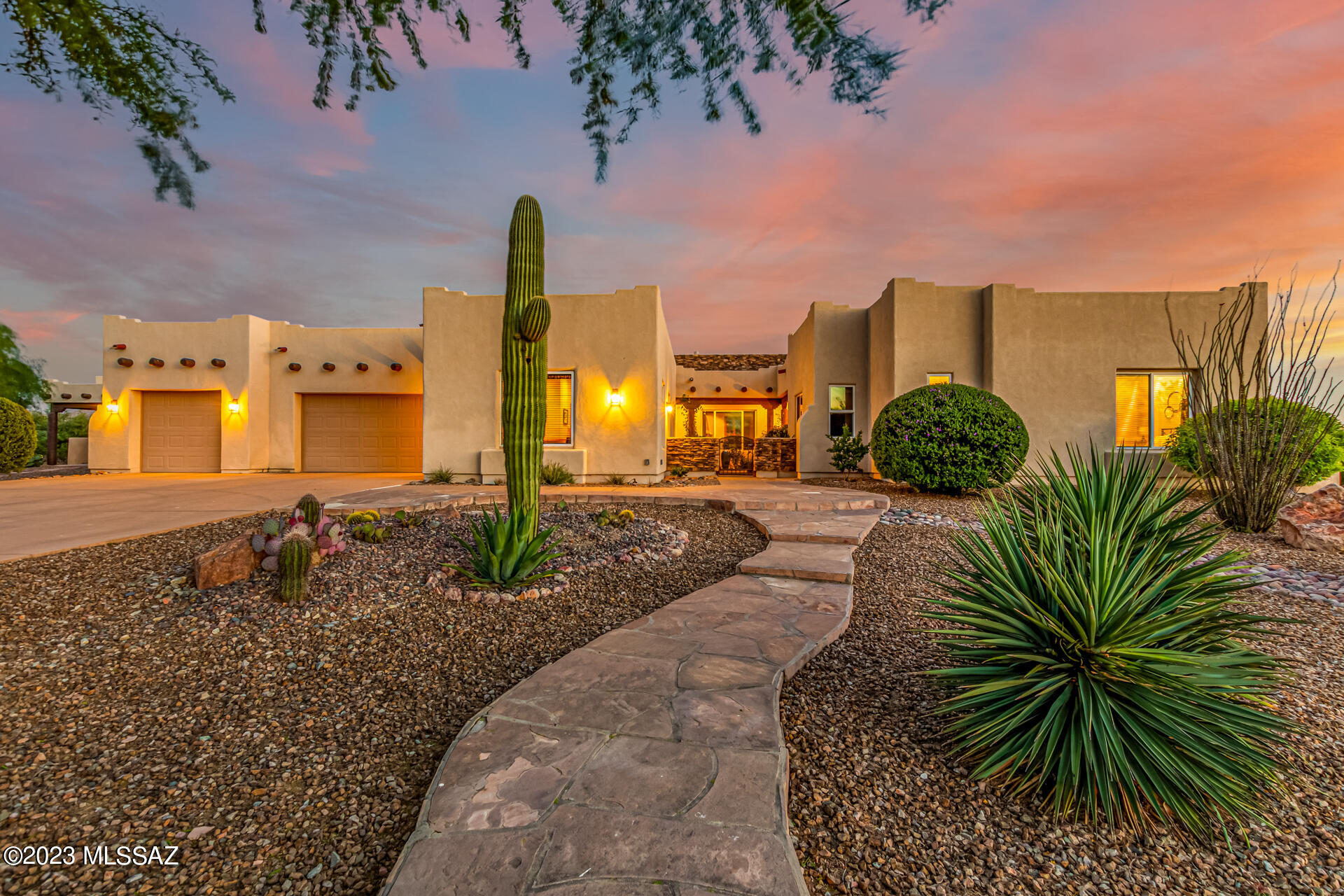 Introducing a luxurious, energy-efficient corner lot home nestled amidst breathtaking mountain views w/no neighbors behind! This exquisite property displays a 3-car garage w/an extended driveway, a charmingly paved pathway, & a desert landscape. The exterior is adorned w/striking stone accents, enhancing the home's curb appeal, while the private courtyard welcomes you to your oasis. Upon entering, you'll be captivated by the bright formal dining room, complete w/picture-perfect windows & decorative light fixtures. Well-sized living room offers plantation shutters, pre-wired surround sound, a projector w/screen, & a cozy fireplace to warm up those cool desert evenings. The 634 sq ft. guest house gives your guests their own private entrance, kitchen and spacious bathroom. Remarkable gourmet kitchen boasts upscale SS appliances, wood cabinetry, granite counters, stylish tile backsplash, a walk-in pantry, a center island w/a breakfast bar, & a bay window that showcases the awe-inspiring mountain views, as well as elegant French doors that lead to the spacious backyard. An expansive bonus room, perfect for a home office or a 5th bedroom, features a double-door entry, sophisticated wood panel accents, & convenient access to a hall bathroom. Grand main suite is truly a sanctuary that comes w/multiple exits, a relaxing sitting room w/a bay window, a deluxe ensuite w/two sinks, a separate tub, & a generous walk-in closet. Secondary bedrooms have walk-in closets. Detached guest's house provides exceptional accommodations for visitors, with a sizable living & dining area, a practical kitchenette, & a private bathroom. The fabulous backyard is an entertainer's dream! Offering a covered patio w/an exterior fireplace, ceiling fans, a fountain, lush landscape, vibrant vegetation, & palm trees. Sports enthusiasts will enjoy the basketball half-court, while the sparkling swimming pool invites you to cool off & unwind in style! Finally, take in the dreamy mountain views surrounding this desert oasis, providing an unparalleled living experience! Truly a must-see!