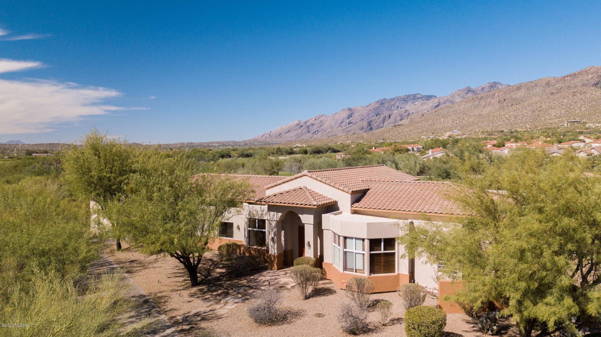 Stunning, one of a kind, custom home at the end of Sabino Springs in the Arizona National Premiere Golf Course Community. This beautiful home sits on almost a half acre, Golf Course lot that showcases a view of the Catalina Mountains. The back covered patio extends the entire length of the home for the ultimate, outdoor living experience; from BBQing in the outdoor kitchen, entertaining, catching laps in the swimming pool, relaxing in the spa, or just taking in the view. Privately located at the end of the cul-de-sac, this home is filled with luxury inclusive of an 8 foot entry door, octagon kitchen for the home-chef, walk-in wine cooler, wet bar, large bay windows, his and hers closets by Classy Closets, media room/ spare bedroom, outdoor California lighting, extra room that can be used as an office, bedroom, or den, a central vacuum system, home water softner (2020), security system, and so much more. Located near Sabino Canyon and Mount Lemmon, hiking trails, shops, restaurants, good schools, hospital and church. This home is ready to be your desert oasis.
