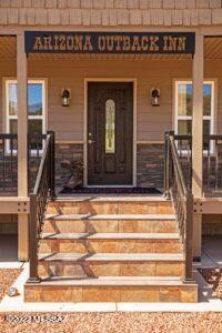 Beautiful custom home on 6.36 acres in the Vail school district. Inviting and Open floorplan. Dark wood flooring throughout  4 bedroom/ 4 bath suites, each with sliding door opening on to the wrap around deck to sit and enjoy gorgeous mountain views. Features a metal roof, high ceilings and 2 ac units. Large detached garage with an additional bonus room that includes a 1/2 bath and serving area with fridge. Gazebo out back. Horse property. All Furniture stays. Wonderful family home or a great Investment property. One of a kind property!