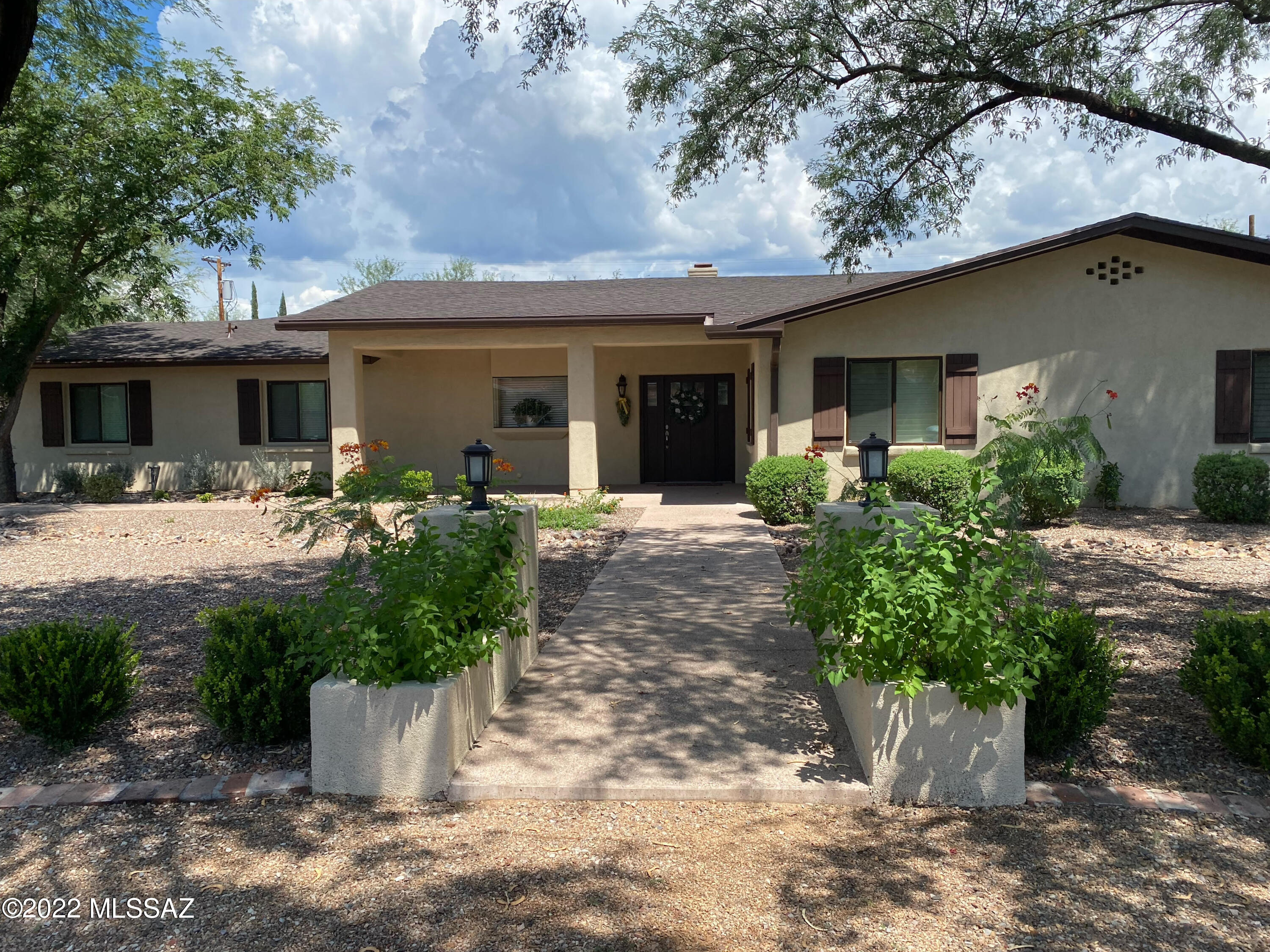 Extensively renovated home located in guard-gated Tucson Country Club Estates on a desirable  interior street with a north facing backyard. Charming walkway leads to an inviting entry with a new kitchen w/ center island, spacious dining area,  double-sided fireplace and a family room. Sliding glass doors access the completely landscaped backyard with a deep and long covered patio, pool & low-maintenance turf. Split bedroom floor plan with guest suite recently added. New 3- car garage.