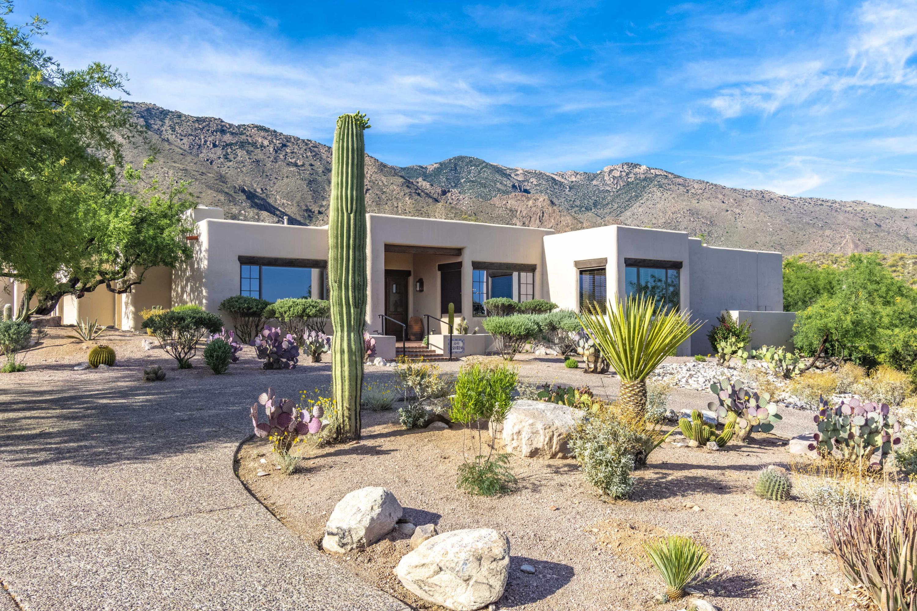 A fabulous turn key home that is located in the private manned gate community of Finisterra estates in Tucson, Arizona, awaits your visit. Located on a cul-de-sac with North-South elevation, this home features include soaring ceilings and has panoramic views from most windows. There are 3 bedrooms/ 4(3-1) baths, with a split floor plan, breakfast room, family room, formal living and dining room, and two laundry rooms with storage.   The kitchen has Subzero and Dacor appliances, a wine cooler, with granite countertops and an enlarged island, as well as a desk and walk in pantry.   The rear covered patio has a built-in barbeque and low care plants and a completely fenced-in back yard.  Close to the year-round heated Community Pool and Spa, Clubhouse and Tennis Courts. Close to shopping, hiking and golfing areas.