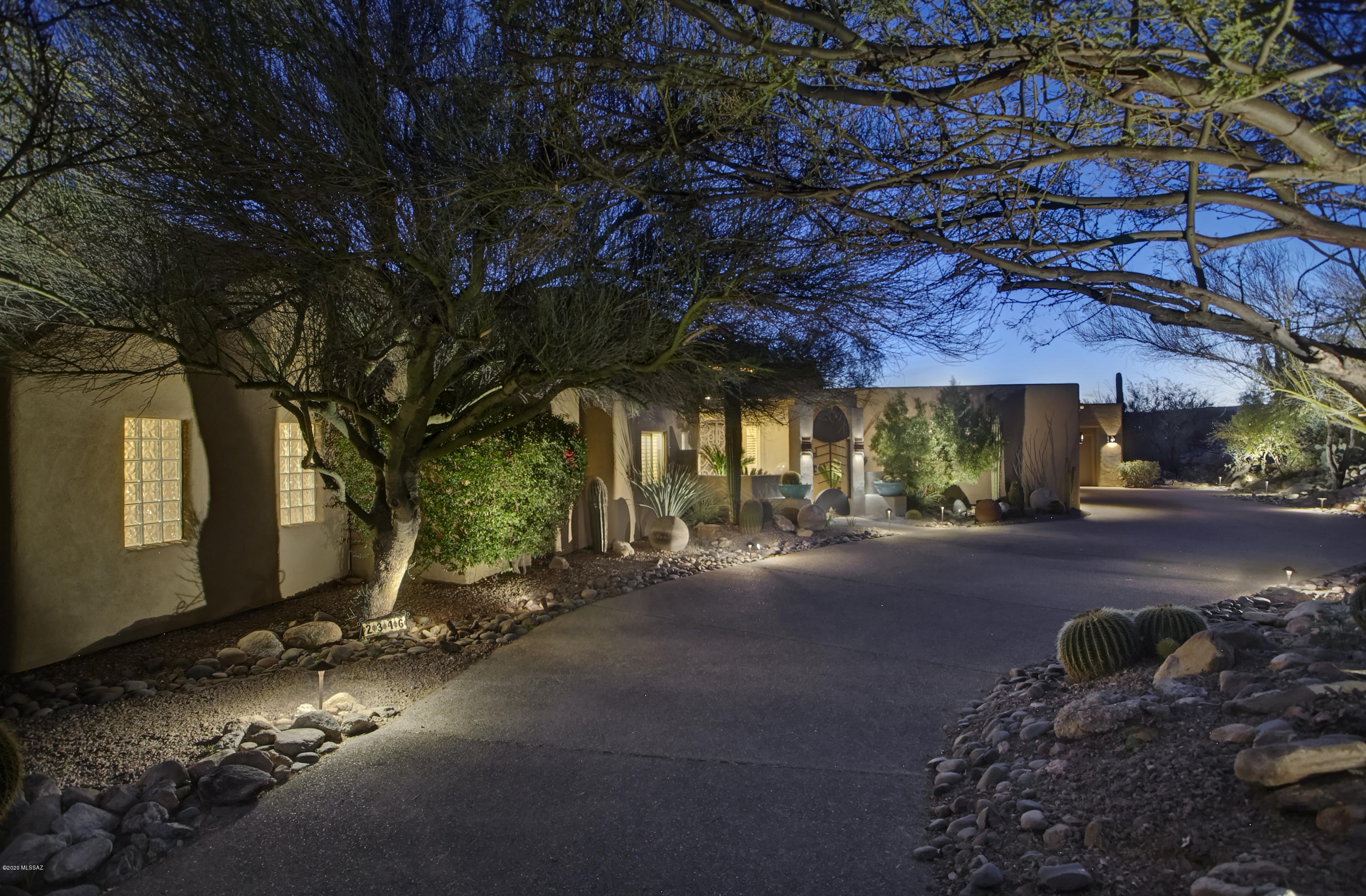 Nestled at the base of the Catalina Mtns, overlooking the twinkling city lights, sits this stunning desert contemporary home in the guard gated Enclave at Pima Canyon. A courtyard w/custom gate & fountain welcome you into this spacious home built on one of the best view lots in the Foothills! 4 bdrms all en-suite + stylish powder rm, timeless flagstone floors, ample wall space for a large art collection, high ceilings & NO interior steps. Spacious mstr suite features an exercise rm, large walk in closet & fireplace. Gourmet kitchen w/stainless appliance & center island w/gas range opens into the family rm w/art display wall & bar for entertaining.  Expansive covered patio w/gas fireplace overlooks the negative edge pool/spa & exquisite new landscaping. Tesla solar system & 4 car garage!