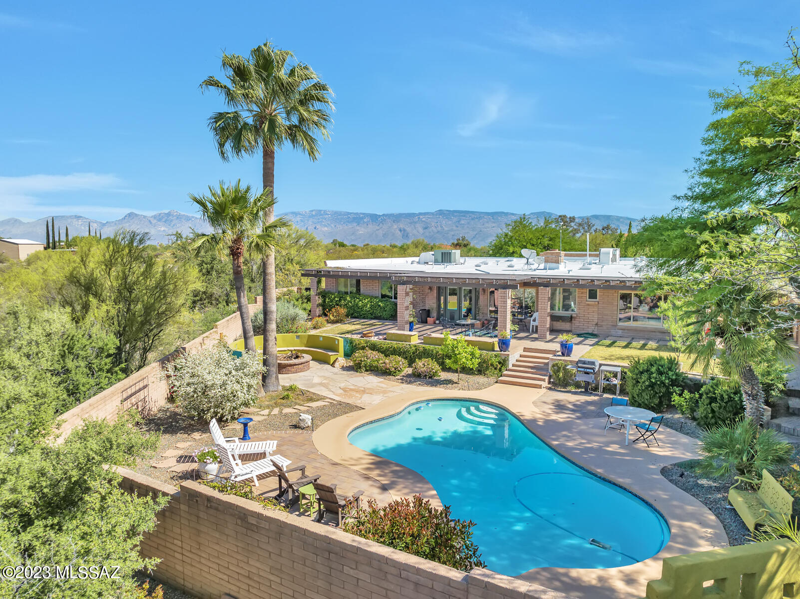 Charming and Artistic Contemporary Territorial nestled on 4.76-acres of natural desert in the Rincon Mtn foothills. ¼ mile from Saguaro Nat'l Park East. Chef's kitchen with granite countertops, gas cooktop & large walk-in pantry. Large Great Room, split bedroom floor plan. Updated landscaping with dramatic low voltage lighting, firepit, pool and poolside areas, expanded front courtyard. Lots of space for additions, horses and parking. An attached 2-car garage plus a detached temperature controlled 2-car garage/workshop, both with insulated ceilings. Well maintained home with thoughtful touches and additions, including Venetian plaster, glazed walls, and illuminated tray ceiling in master bedroom. New HVAC 10/2022, 3yr warranty on the newly 10/2022 coated roofs & freshly recoated pool deck