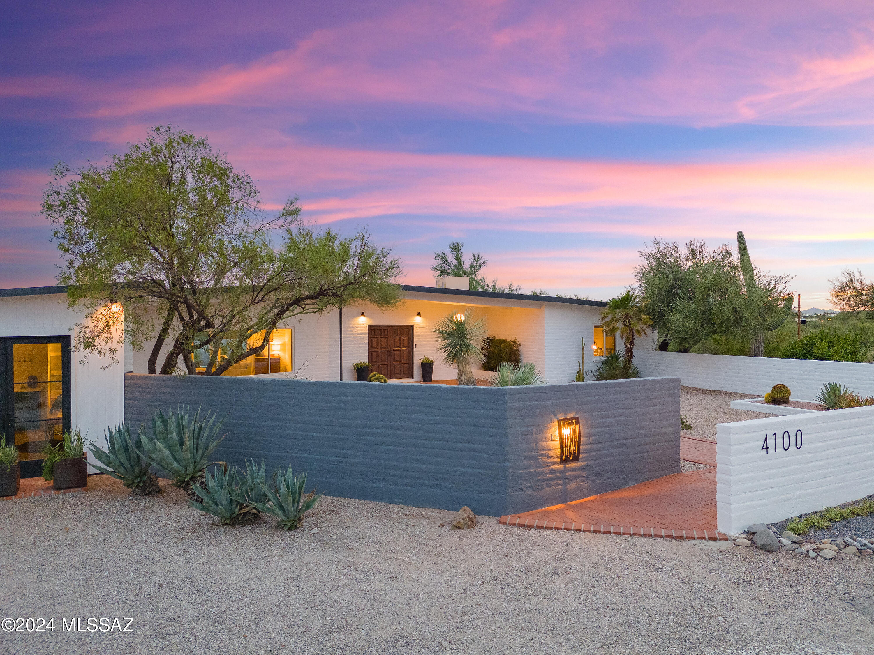 Seller will accept or counter offers between $1,335,000 and $1,390,000. Immerse yourself in luxury living within this stunning Mid-Century modern masterpiece crafted by the esteemed Veronica Hughart, celebrated for her innovative and sustainable architectural designs, renowned for her seamlessly blending modern aesthetics with eco-friendly practices, Hughart's creations elevate living spaces by harmonizing with nature, promoting well-being, and advocating for sustainable architecture. This meticulously renovated residence preserves the timeless allure of its 1961 origins while seamlessly integrating contemporary comforts. Works included- Josler Loerpabel House.   Nestled atop a hill on a sprawling 1.88-acre private lot, it offers unparalleled vistas of the city and Catalina Mountains, enveloping you in the captivating beauty of the expansive front yard, where sleek porcelain floors, lofty beamed ceilings, and expansive windows frame panoramic views from every angle. Charles Bolsius' antique wood-carved doors, exquisite light fixtures, and meticulously painted interiors enhance the ambiance of each space. The thoughtfully designed layout features a luxurious split floorplan, showcasing exquisitely remodeled bathrooms all feature en suite bathrooms and a lavish powder room adorned with a striking cement tile backsplash. The primary suite exudes sophistication with a built-in bookcase, private patio, and a Classy Closets-designed closet. Pamper yourself in the opulent en suite bathroom, boasting a porcelain soaking tub, Italian marble accents, and a separate glass-enclosed shower. The gourmet kitchen, a focal point of elegance and functionality, boasts Canyon Cabinetry, Detkton Counters, and high-end stainless-steel appliances, including a Monogram refrigerator and a sub-zero cabinet drawer beverage refrigerator. The adjacent studio or den, complete with a wet bar and Milgard fiberglass double doors, offers additional living space for utmost versatility. Outside, the meticulously landscaped backyard by Civano Nursery beckons with an array of entertainment options, including an expansive patio, sparkling pool, lush turf, and captivating city views. Whether relaxing or hosting guests, savor the epitome of luxury living amidst Tucson's serene sunsets and twinkling city lights. Experience the pinnacle of sophistication and comfort in this meticulously curated sanctuary, where every detail embodies refined living at its finest.