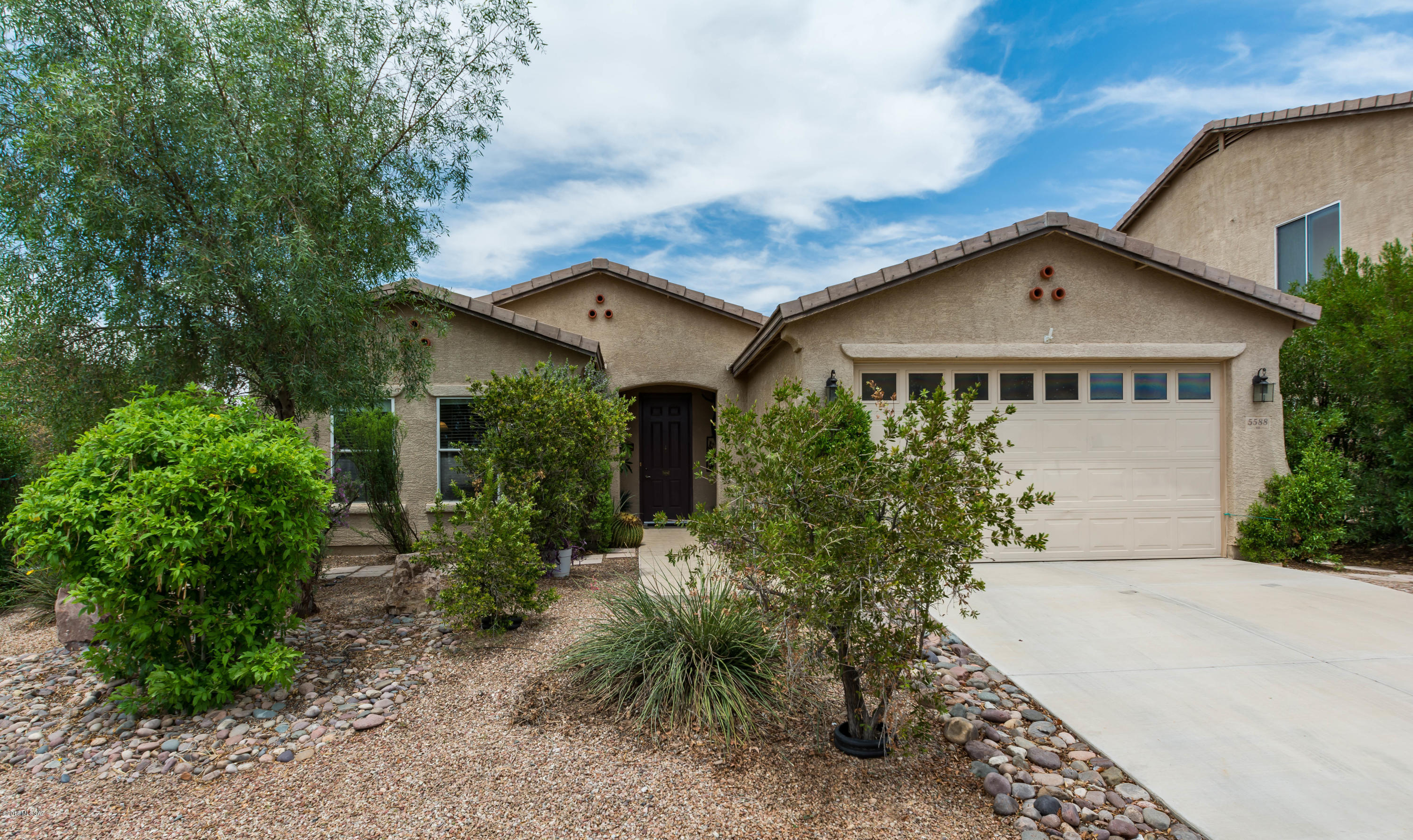 A true oasis in the desert. This gorgeous home backs to open area (once protected owl habitat) - unobstructed sunset, desert & mountain views w/abundant privacy. Backyard is a Hawaiian paradise. Raised garden beds built of wood-look concrete, grassy area for pets/children - spacious covered porch - very mature landscape - a truly peaceful, serene location. Inside you will find upgraded Italian tile flooring throughout much of the home. Open great room concept w/formal dining area (if desired), along with kitchen dining nook, breakfast bar, kitchen island workspace. This home was built with 9ft ceilings (standard in subdivision was 8ft), higher toilets & vanities, expanded tile front walkway & rear porch. 8ft x 6ft storage shed on side yard conveys, along w/all kitchen & laundry appliances.