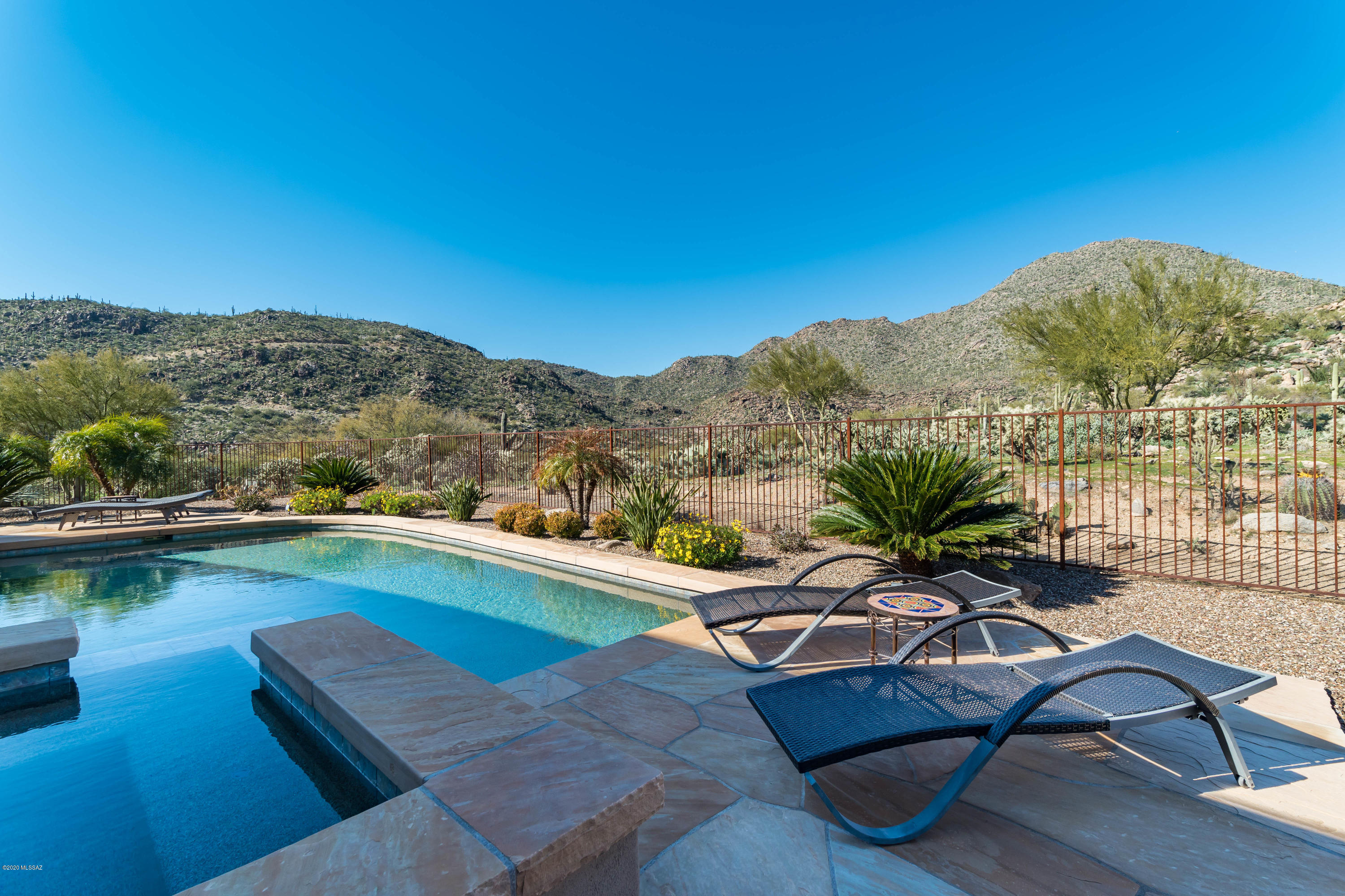 Custom Luxury home in gated Vaquero in Canyon Pass at Dove Mountain. Situated on a private cul-de-sac bordering the 6th fairway of The Gallery North Course, this home also backs to the Tortolita mtns offering privacy and stunning views. Charming gated courtyard leads to an open, inviting floorplan featuring formal dining room, great room w stacked stone fireplace and wetbar, adjoining
kitchen w gorgeous granite counters, Wolf appliances, SubZero fridge & wine cooler. Elegant Master
Suite features amazing views, cozy fireplace, jetted tub & large walk-in closet. Perfect for entertaining w extended covered patio, pool/spa, firepit, Wolf grill & fridge and Sonos sound system throughout the home and patio. Beautiful private guest house Casita, as well as a pool bath w shower. Amazing home