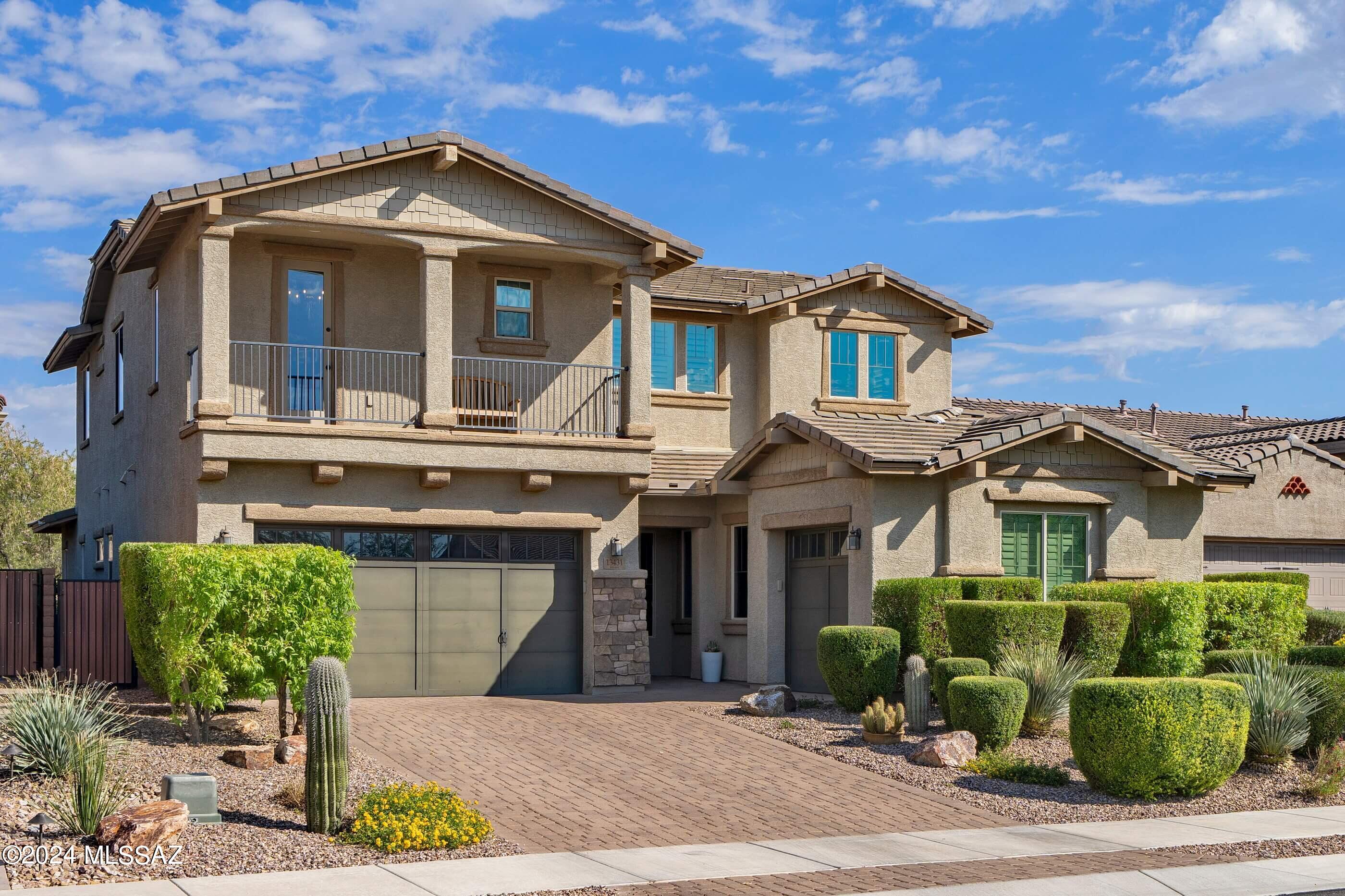 This 3687 square foot former Maracay model home in gated Center Pointe Vistoso is loaded with upgrades! There is space for everyone to spread out—four bedrooms + a den, three and a half baths, a large open living space downstairs and a massive loft. Touches like the coffered ceilings and custom wainscoting in the primary bedroom, den and dining room and the chic herringbone tile feature walls make this home a stand-out. On the lower level the owners will enjoy privacy in the large primary suite overlooking the green outdoor space and easy access to the laundry room through the walk-in closet. The ensuite bath has dual sinks, custom to-the-ceiling backsplash and an oversize shower with beveled subway tile and a striated tile basketweave floor. The lower-level living space is open to the k tchen and has a herringbone tile feature wall with a gas fireplace. You'll be able to have all the kitchen gadgets you wantthe entire eat-in kitchen is lined with cabinetry, including storage under the large kitchen island with breakfast bar. This kitchen also features quartz counters, on-trend matte motif tile backsplash and all appliances, including a gas range. The lower level is rounded out by a large separate dining room off the main hall that will host everyone, a den and a dramatic half-bath with bold tile wainscoting. Upstairs, the huge loft with peeks at the mountains has a stunning tile feature wall, built-in cabinets topped with a quartz counter and pendant lighting. Other extras include a ceiling fan, clerestory windows and a barn gate for keeping pets or kids away from the stairs. One of the upper-level bedrooms has its own ensuite bath, walk-in closet, picture frame molding feature wall, chandelier and a balcony with mountain views. Two additional guest bedrooms also have walk-in closets and are services by a full hall bath. Custom lighting throughout this home and window coverings on most windows. The garages have room for three carspark in both or use the separate one-car garage for storage or a home gym. The beautiful, private outdoor space is fully landscaped and ready for entertaining or to be used as a quiet retreat. This lush space includes travertine pavers, faux grass, mature plants, travertine pavilion with pergola, built-in BBQ with dining bar and a truly spa-like water feature. Center Pointe Vistoso is a sought-after community in the master planned Rancho Vistoso development in Oro Valley. Comprised of five gated individual neighborhoods, Center Pointe at Vistoso features an outstanding 6,000 square foot pool complex and interactive splash park with stunning views; picnic, BBQ and firepit areas, a butterfly garden, play structures and interconnected trail system, community park with play structures, activity lawn and more. Nestled against the western foothills of the Catalina Mountains and south of the Tortolita Mountains, the beautiful and well-managed town of Oro Valley has received accolades in numerous acclaimed publications including Fortune Small Business Magazine, Money Magazine and renowned powerhouse publication Family Circle.