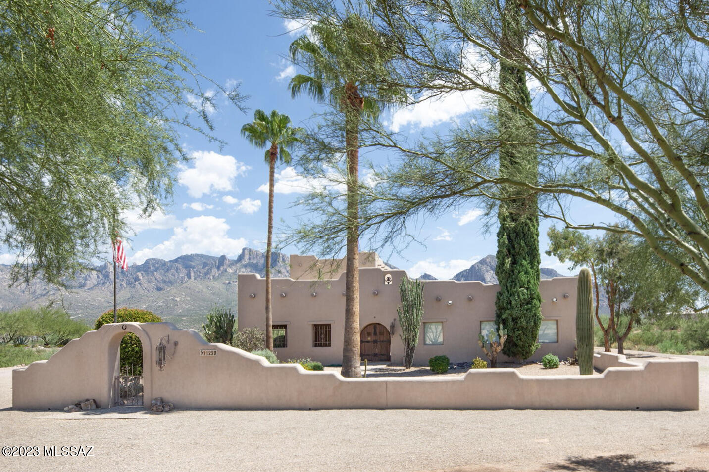 If you are seeking a home in the Oro Valley area with 
Mountain Views, No HOA, and a Large Lot - Look No Further! 

This well cared for 3 BD  / 3 BA Santa Fe style home is Extra Special, as it sits on 3.37 acres with Sensational Panoramic Views of the Santa Catalina and Push Ridge Mountains, offers sizable living space throughout, and is located in close proximity to schools, shopping, entertainment, and recreation. As you make your way to the beautiful front entry courtyard that is shaded, you quickly realize just how unique and special this property truly is. Dramatic double entry wood doors welcome you to a spacious floor plan that is designed for entertaining and comfortable living.

The main level boasts a grand Great Room with a gorgeous exposed wood beam ceiling, an impressive dual sided wood burning fireplace, and offers a designated space for media entertainment. Next to the Great Room is the formal Dining Room, which is sure to please with its large arch entry and double-sided fireplace that offers a delightful ambience for special occasions. The Sunroom boasts spectacular panoramic mountain views and offers that additional space that might be desired for casual dining, recreation, crafts, or any other need your lifestyle calls for, and provides rear patio access. The updated kitchen is perfectly suited for entertaining, and features maple wood cupboards, marble countertops, a passthrough window to the rear patio, and a large sit-up bar with copper face. Adjacent to the kitchen is the Laundry Room with built-in upper cabinets and front load washer and dryer, a private Office / Bonus Room with rear patio access, and a Bathroom with walk-in shower that has exterior access to the patio and pool as well. 
All bedrooms are extremely spacious. Bedroom 2 features a walk-in closet, while bedroom 3 is aesthetically pleasing with a beehive fireplace (electric logs only) and glass sliding door that overlooks and provides access to the front courtyard. Shared by the lower level bedrooms is a Hall bath with single sink vanity and large soaking tub with shower. Located on the 2nd Floor is your own private retreat, as the Primary Suite offers a private balcony boasting breathtaking views. The ensuite bath provides lots of storage space, a single sink vanity, large walk-in shower, and wet room.
Enjoy time spent outside with family and friends, as the expansive covered patio boasts magnificent panoramic mountain views, and overlooks the "Family-Size" swimming pool with diving board. The rear patio features a dry bar, sun shades, and misting system for added comfort on summer days. And the Pool area with kool deck provides plenty of space for sunning and offers an outdoor shower and gazebo. 
The front courtyard provides access to the 2 Car Garage, which offers a utility sink and large work shop with built in storage cabinets. Adjoining the garage is the extended carport with side walls and a wrought iron security gate. If needed, the property offers plenty of additional space for parking, RV, toys, and more. The entire home has 12 inch walls, keeping the house comfortable and energy efficient. All 3 HVAC units are newer, interior has a fresh coat of paint, and the roof, balcony, rear patio and Kool deck have just been re-coated. As you can clearly see, this home is not lacking when it comes to size, accommodations, and space to expand. 
Don't miss out on this incredible opportunity!