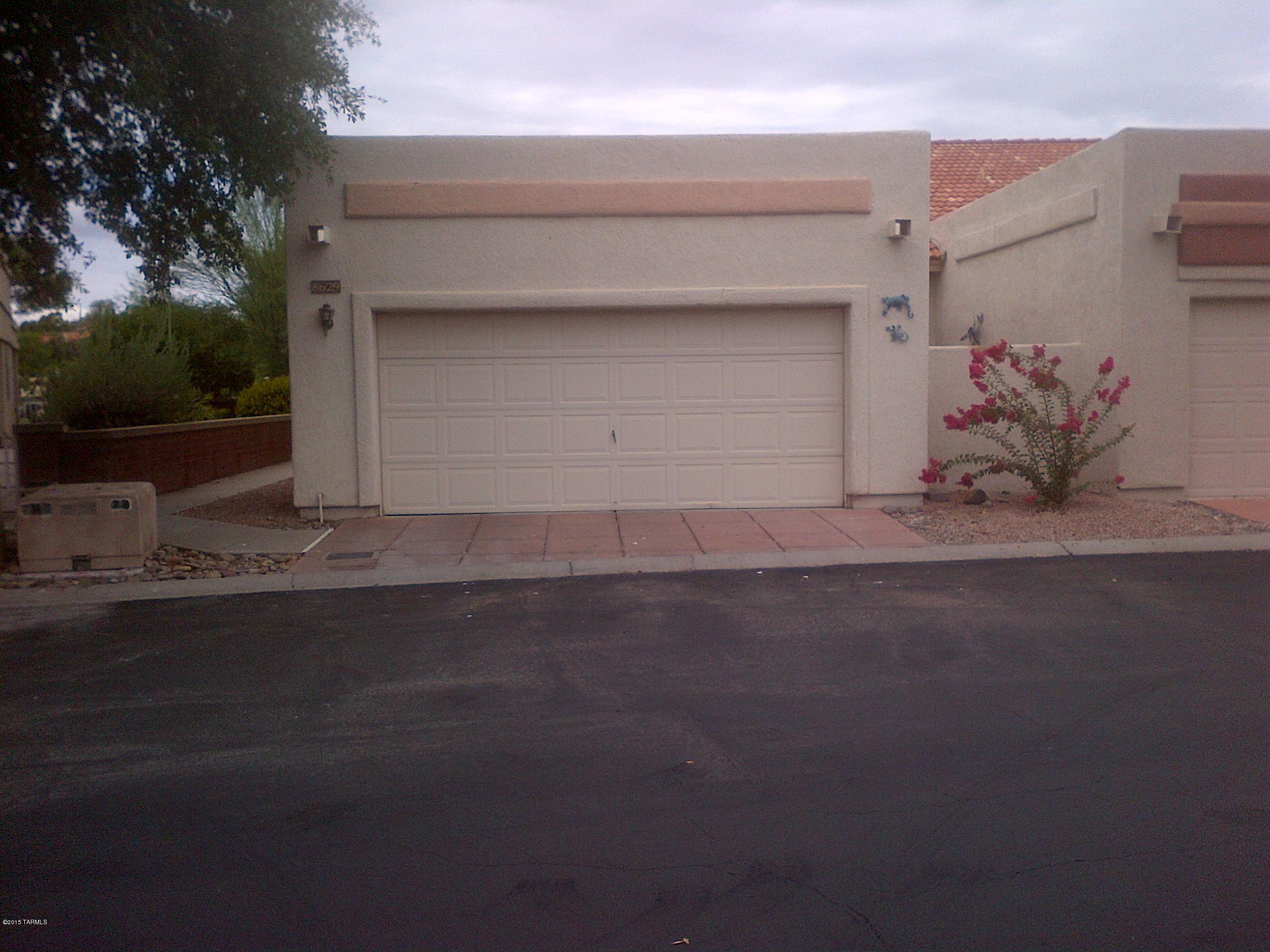 Priced to sell.  Spacious and open 3 bedroom on corner lot.  Needs a little TLC, but is an end unit with lots of windows and great golf course views.   Large master with sliding door leading to private patio area.  Kitchen is open to great room.  Cozy fireplace and finished garage.