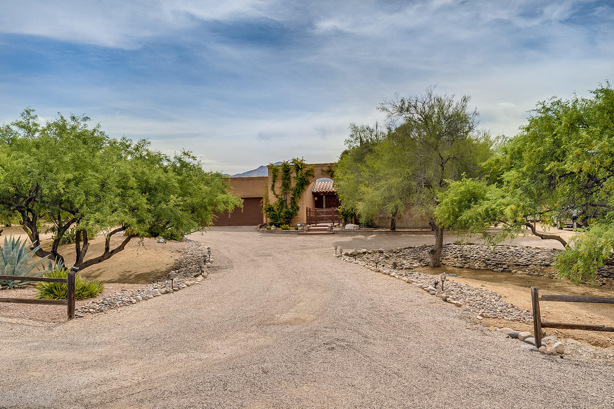 Beautiful 4BR/3BA home on approx.1 acre lot! Beautiful mountain views all around. Located in Tanque Verde Valley, horse property with mature vegetation. Incredible backyard heated pool and spa, large covered patio, great for entertaining! Updated kitchen with stainless appliances, wood and tile throughout. Bathrooms recently remodeled. Extra detached room (288 sq. ft.) with heating and cooling, great for exercise room or game room! Separate storage shed or workshop. Large gravel drive with lots of parking, Garage has cabinets and work bench, extra covered carport on side. New 20 seer, high efficiency  AC unit (2018), new pool heater (2018), basketball court with re-bar, Backyard irrigation system with 3 speeds. Pool cool deck redone in 2015. Extra storage area in laundry room.