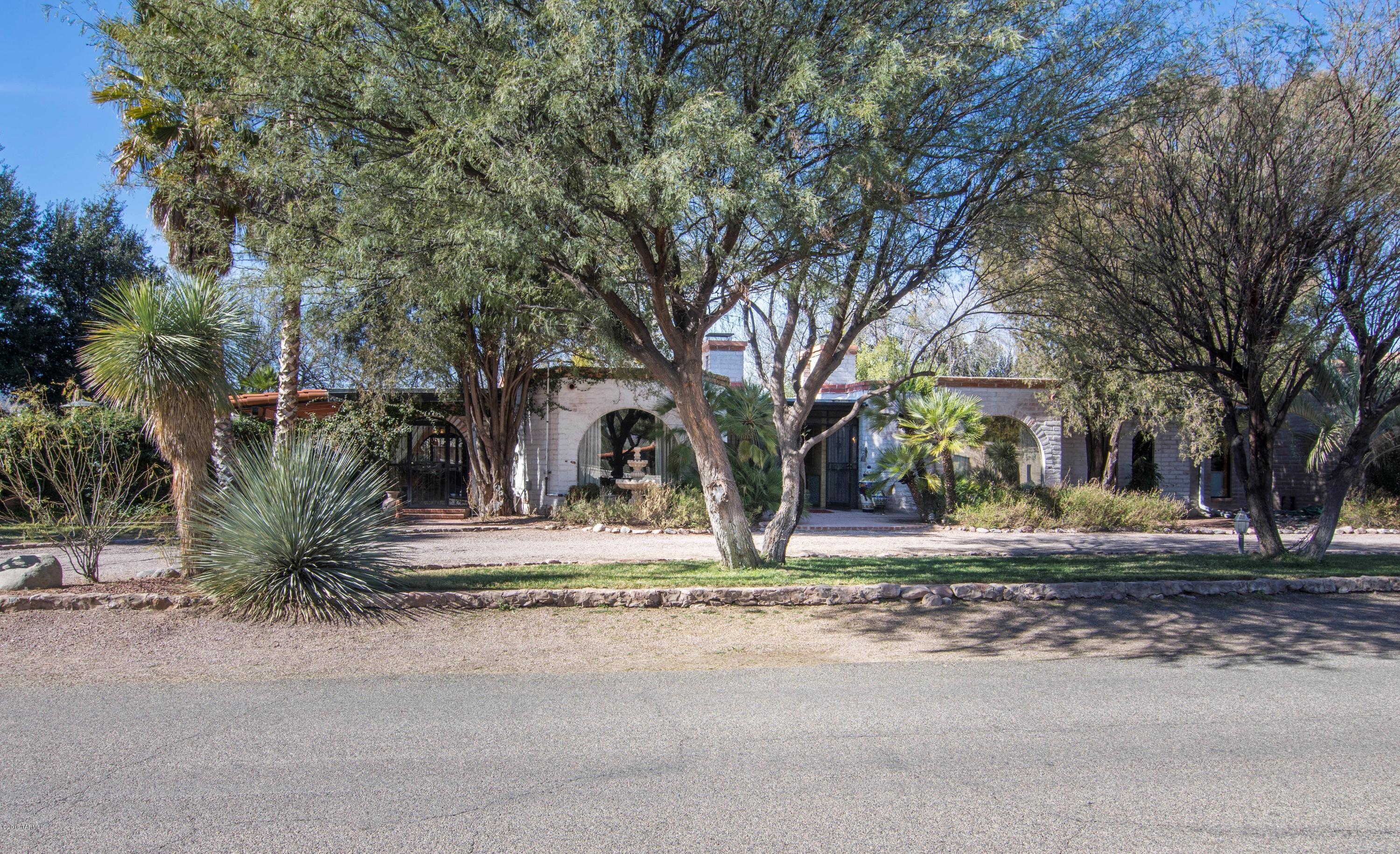 Private Compound in the Heart of Tubac Golf Resort!  Old World Charm & Elegance awaits the most discriminating buyer with Mature Landscaping and Lush Gardens, Meandering Walk Ways and Private Patios, 3 Fountains, Pool, Spa, Built-In BBQ w/Bar and a Serenity Unsurpassed.  This original 3 bd/3 ba Hacienda is beautifully appointed to include 3 FP’s, Mexican Tile, Natural Stone, Wood, Beams, SS Appliances, Library, Rec Rm, Wet Bar, Office, Workshop and So Much More!