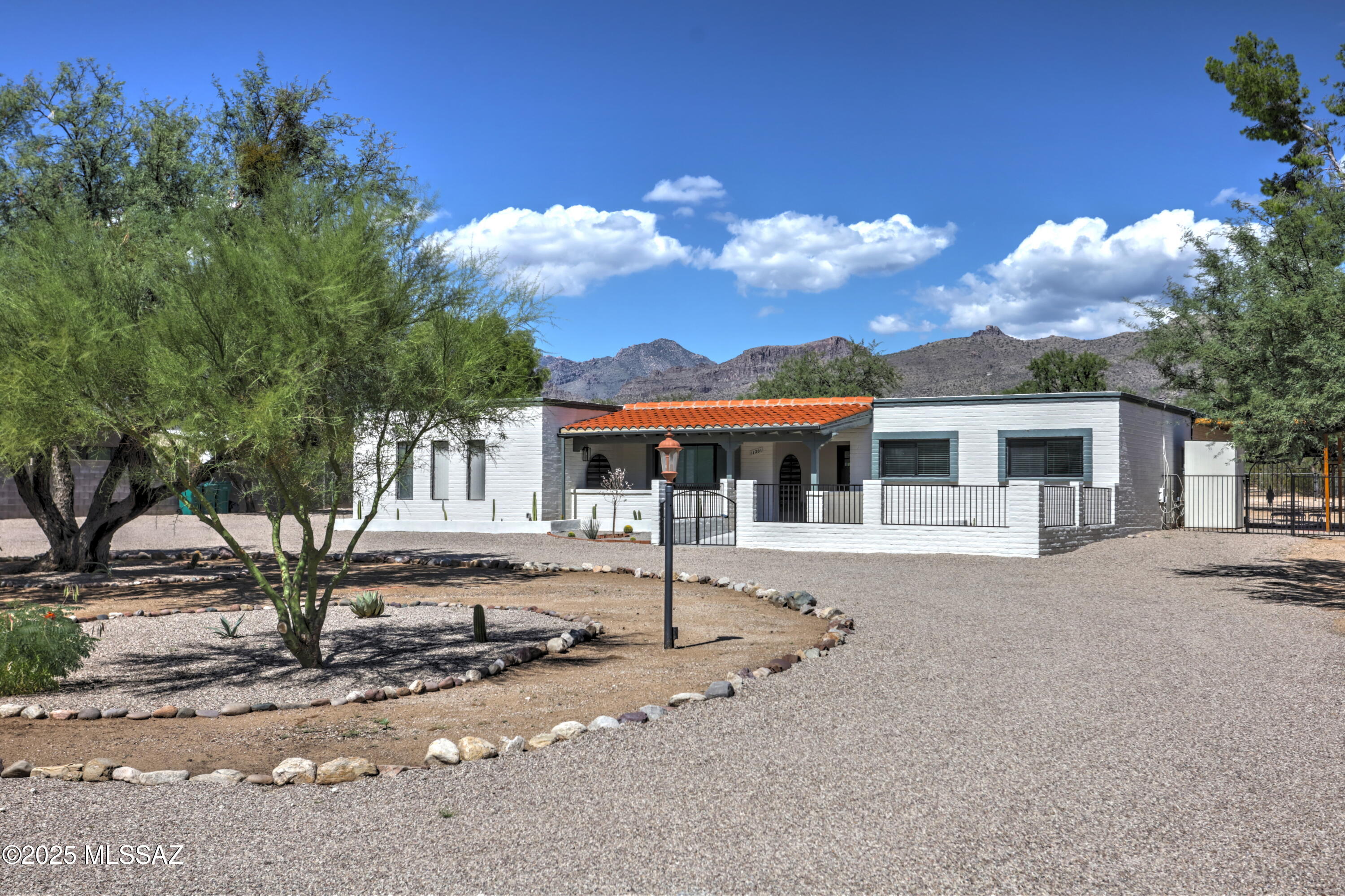 This stunning 1-acre ranch-style home is a SHOWSTOPPER! The main house boasts a gourmet kitchen with two new dishwashers, a stainless-steel stove, granite island, large stainless-steel sink, and a walk-in butler's pantry with stone countertops, new cabinets, and a mini wine fridge. Adjacent is an enclosed Arizona room with a dry bar and mini drink fridge. Upgrades include a new HVAC system, fresh interior and exterior paint, new light fixtures, new water heater, and a resealed roof. All bathrooms are fully remodeled, with the master featuring a walk-in shower in marble. The private main suite opens to a covered patio courtyard. A large dive in pool is an entertainer's dream! The detached guesthouse includes a kitchenette, dining area, living room, full bathroom, and a spacious bedroom with patio access. Large side gate ready to park your RV with plenty of space for a beautiful garden.  Perfect for multigenerational living and entertaining, this move-in ready home offers endless space and luxury. A must see! Owner/Agent