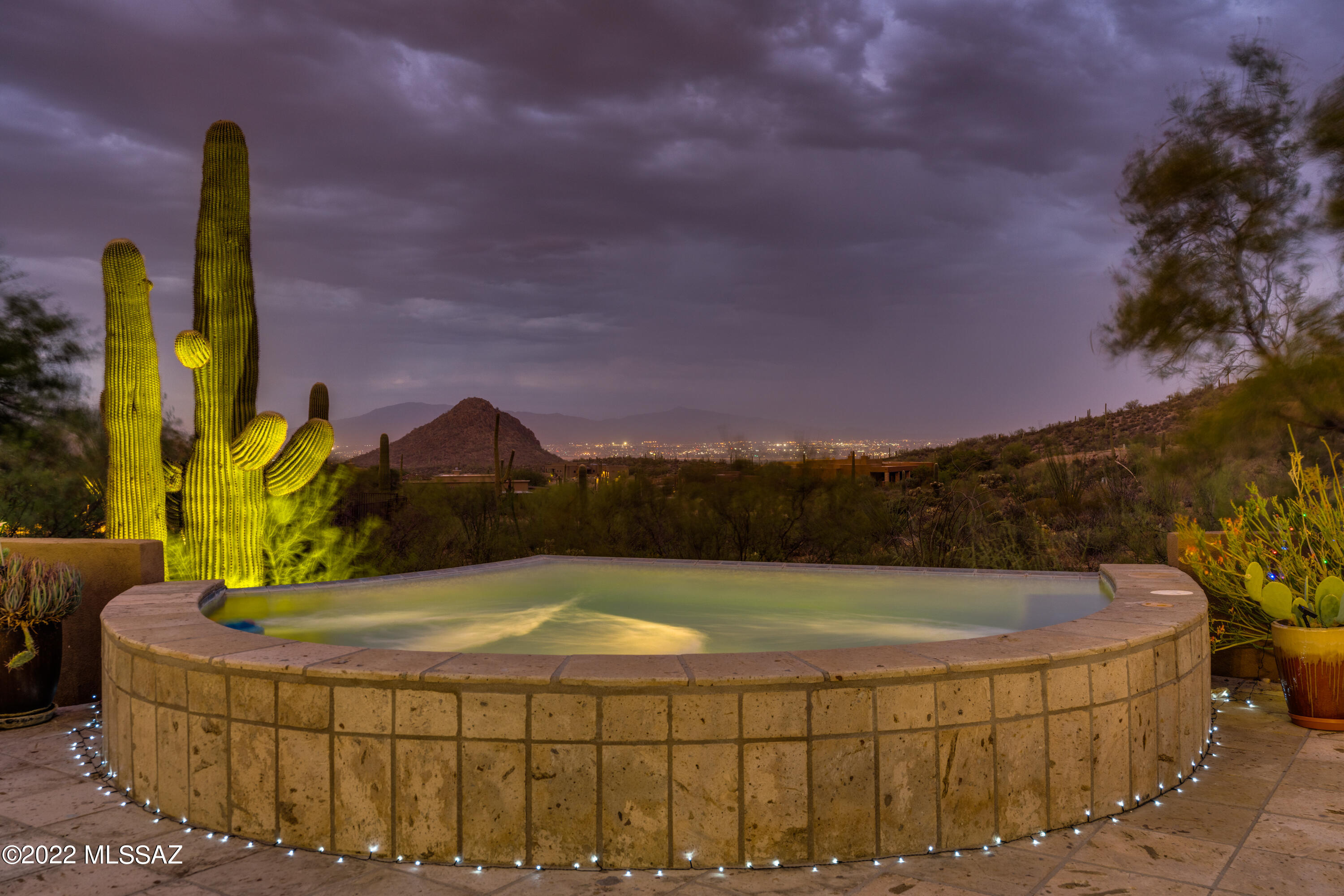 GORGEOUS CUSTOM HOME w/AMAZING UNOBSTRUCTED VIEWS Sits On Over An Acre In GATED WILDCAT PASS, Home Of The JW Marriott Resort & Spa. Enjoy The Arnold Palmer Designed Signature Golf Courses Or Wander Thru This Luxurious Neighborhood Where Nature Is At Your Fingertips.   Savor Cooking In Your Gourmet Kitchen w/Oversized Granite Top Island While Capturing Mesmerizing Views Thru Huge Windows w/Remote Control Shades. Unwind In The Spool w/Jets While Sipping Your Favorite Beverage Enjoying Tranquil City & MTN Views. Outdoor Living w/Built-In BBQ, Fire Pit & Many Seating Areas For Entertaining Family & Friends.  Travertine Flooring Thru Out. Surround Sound, Fireplace & Wet Bar w/Wine Cooler. Mstr Bdrm w/Huge Walk-in Closet & Luxurious Bthrm. Short Distance To UofA, Hospitals, Raytheon, & Downtown!