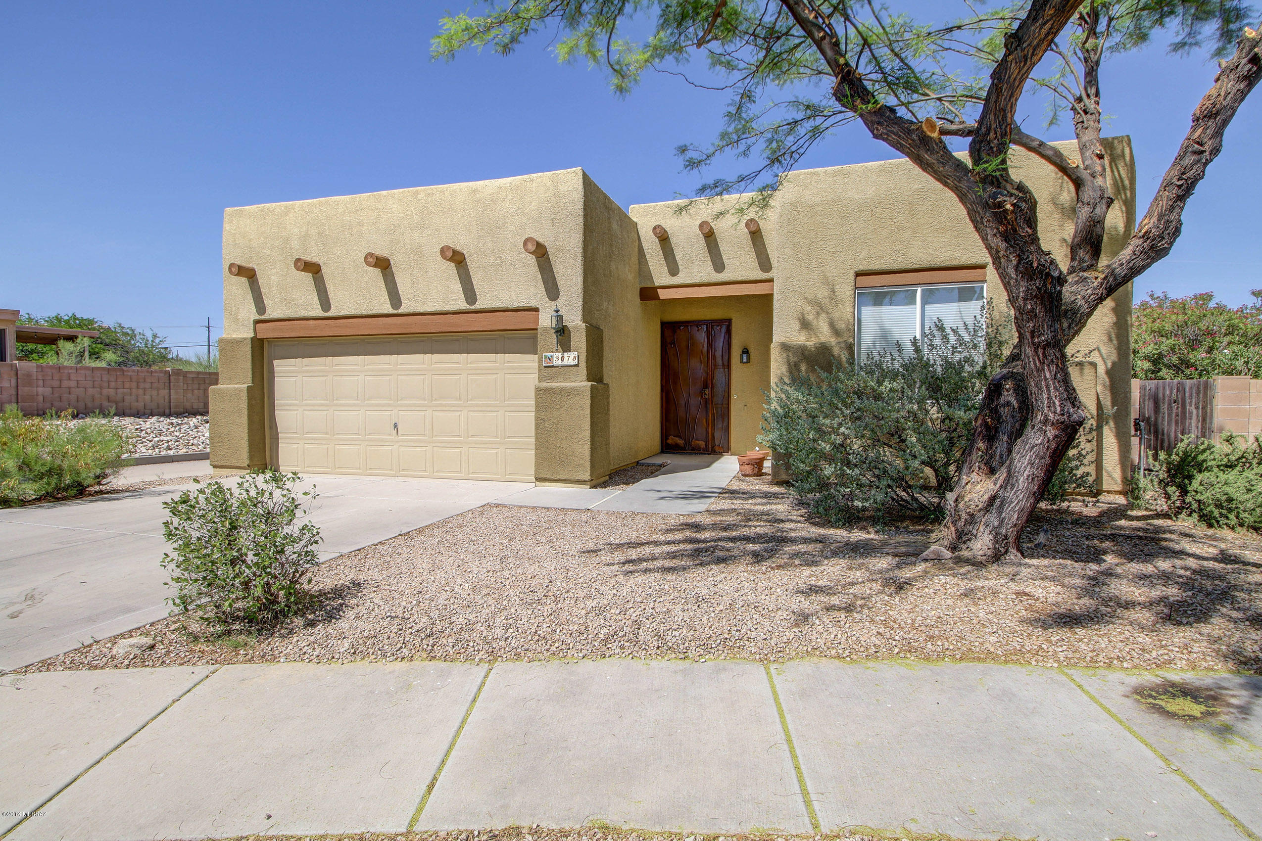 Beautiful Move-In Ready home with Mountain Views!! Highly desirable split floor plan, 3 bed/2 bath, with large bright master suite. Bonus room can be used as an office, den, or easily converted to 4th bedroom. Home boasts floor-to-ceiling natural light in great room, tile & new carpet throughout, and in-ceiling surround sound in every room! Garage includes utility sink right off laundry, with high ceilings for your storage needs. Freshly painted interior, clean landscaped exterior. West-facing back yard opens to North, West and East mountain views. Entertaining yard features long covered patio, built-in gas grill, and gorgeous paver-patio for outdoor dining! Cozy neighborhood minutes from Pima College campus, medical plaza, and quick access to I-10, downtown Tucson city life and the UofA!