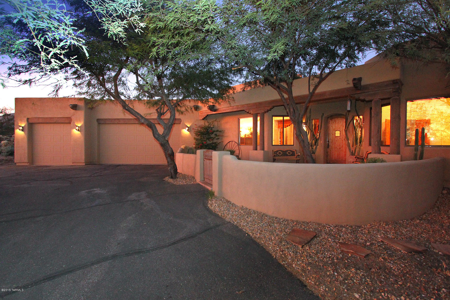 VIEWS & PRIVACY GALORE! Santa Catalina Mountain vistas and sunset views are at your doorstep in this fabulous owner designed, built & crafted luxury Santa Fe home, nestled on 3.3 acres in exclusive, gated Saguaro Hills/Fetzer Ranch. High Latilla beamed & ribbed ceilings & open floor plan accentuate the easy flow of the one level living spaces. Spacious kitchen has custom cabinets, Australian ''verde fire'' granite countertops , SS appliances, and accent lighting. Master suite boasts a double-sided fireplace for relaxing in bedroom sitting area or bath. Perfect for entertaining, the great room & master bedroom access the marvelous covered & uncovered patios, fountains and large pool. And, the Saguaro-studded mountains provide a stunning backdrop to this resort style property.